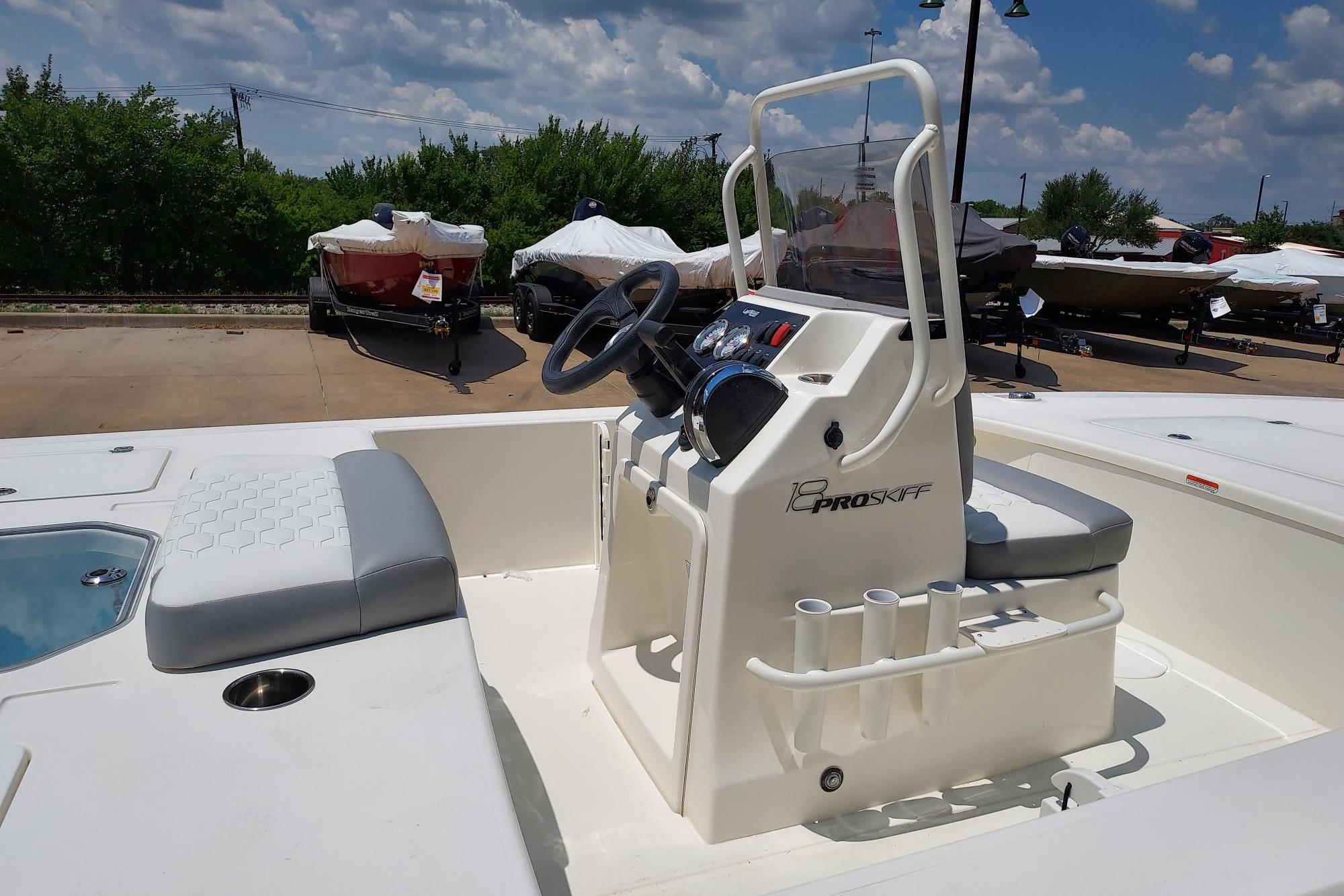 2026 Mako Pro Skiff 18 boat interior with steering console and seating.