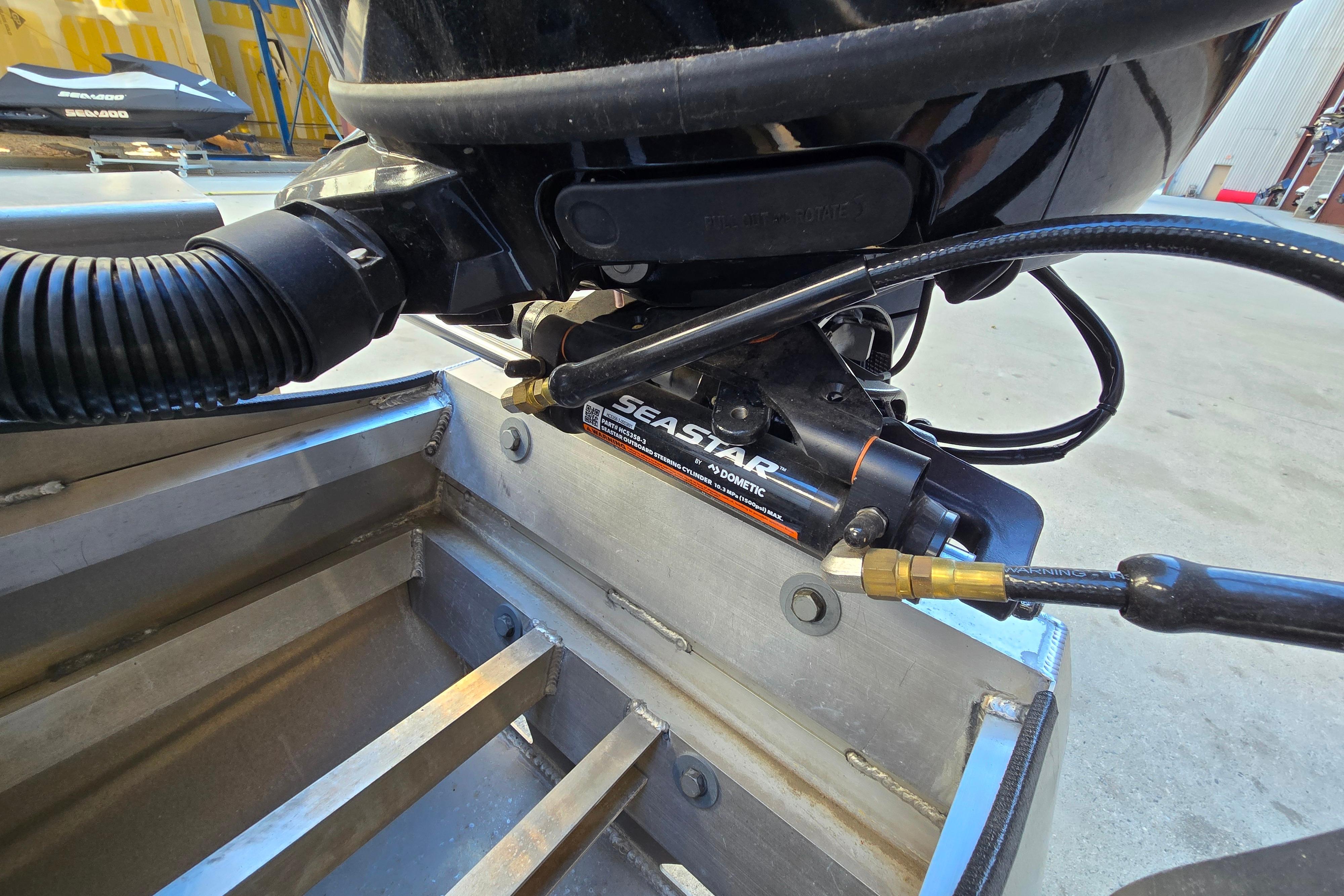 Close-up of 2024 Godfrey Sweetwater 2486 SB boat's SeaStar hydraulic steering system.