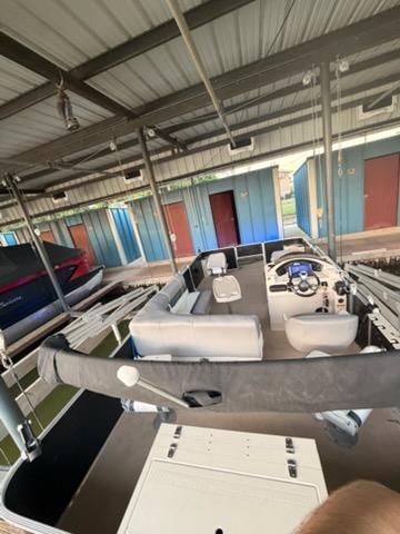 A 2013 Cypress Cay Seabreeze 212 pontoon boat in a covered dock.
