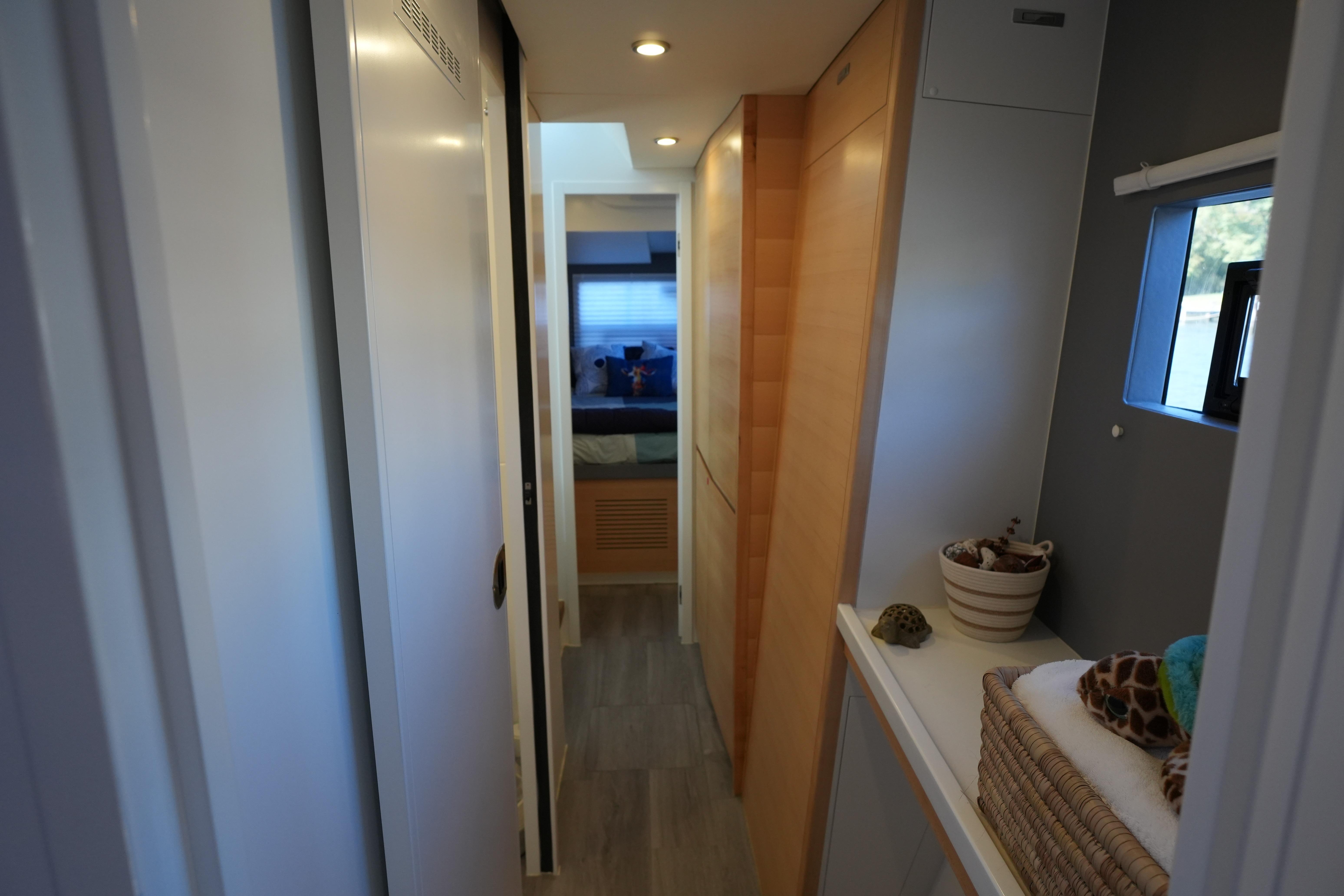 Narrow hallway in 2024 Balance 442 yacht, featuring modern design and cozy interior.