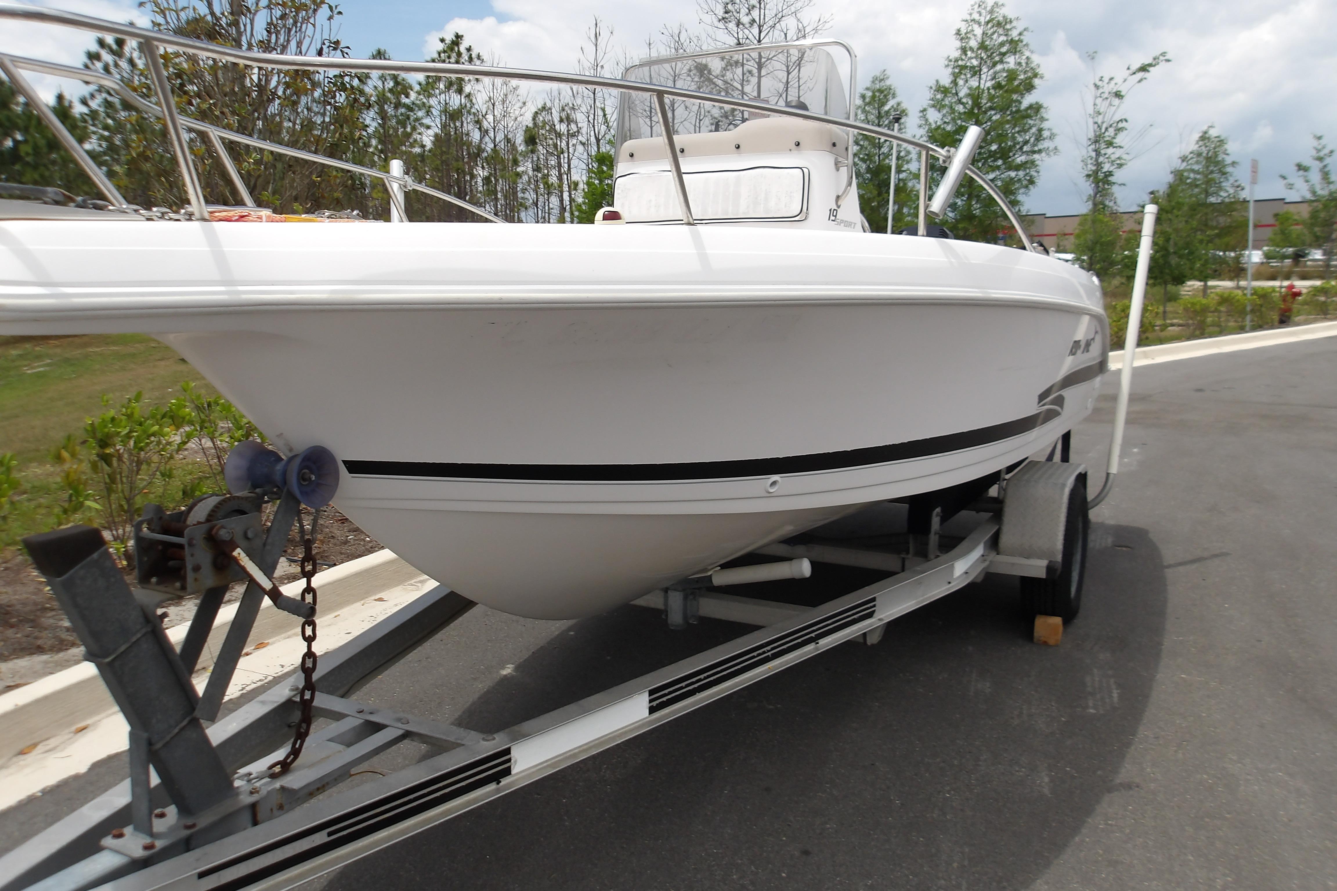 2000 Pro-Line 19 Sport boat on trailer, parked outdoors, side view.