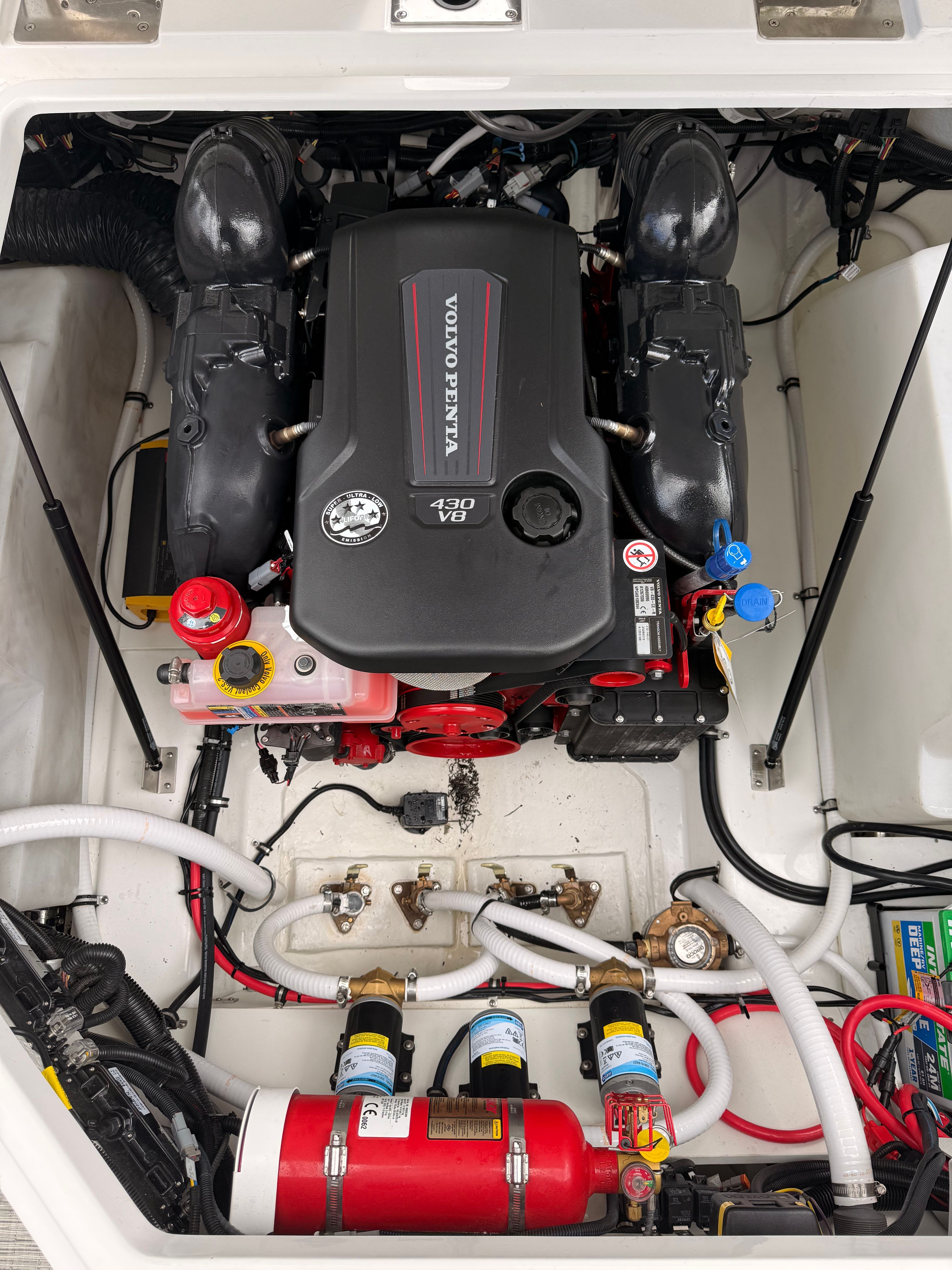 Engine compartment of a Cobalt R8 Surf boat with a Volvo Penta engine and various hoses and components.