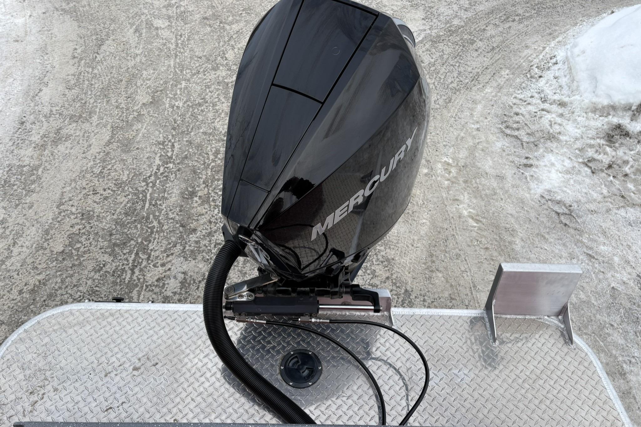 2024 Spartan 240 Maximus Pro with Mercury outboard motor on snowy ground.