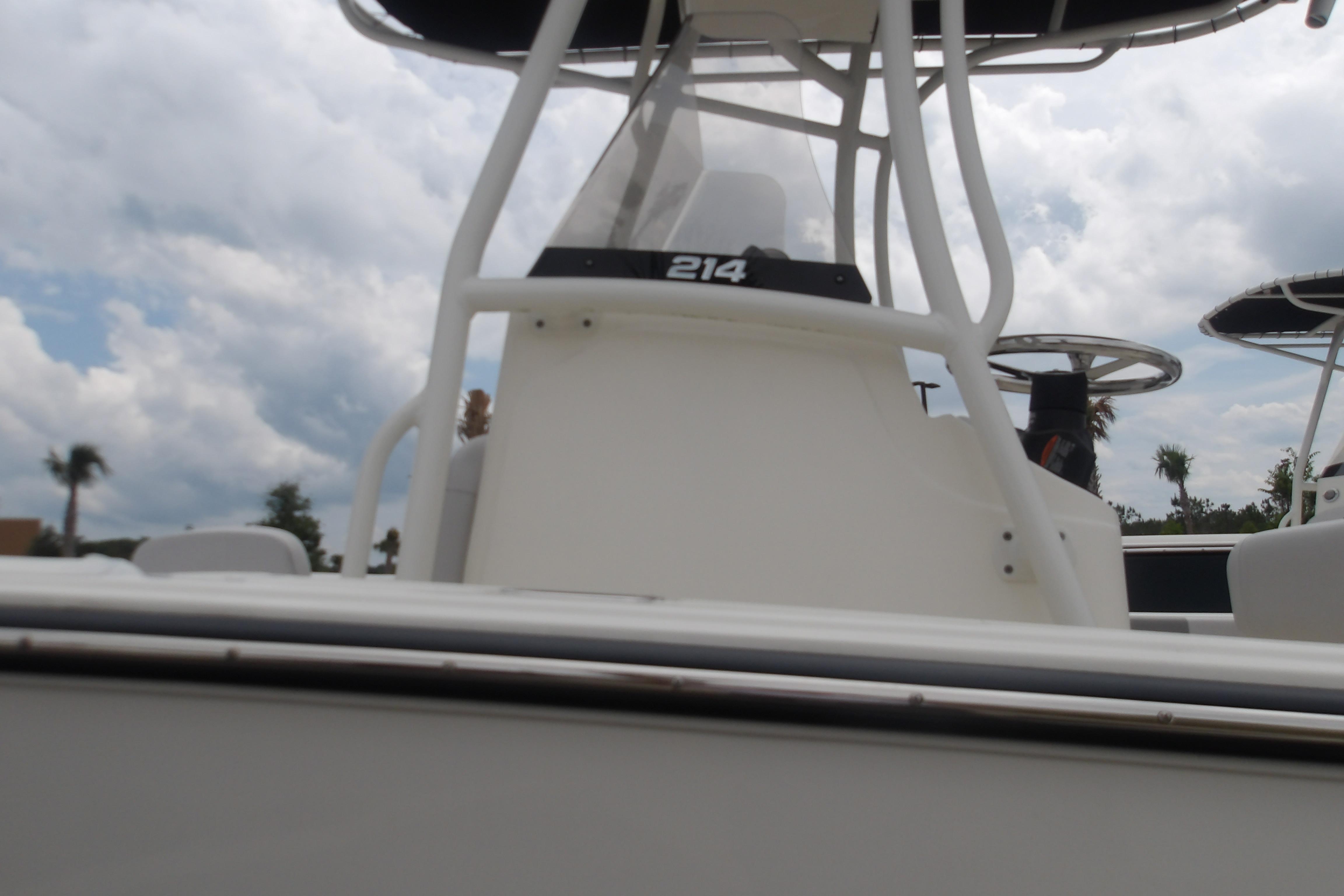 2025 Mako 214 Center Console boat under cloudy sky.