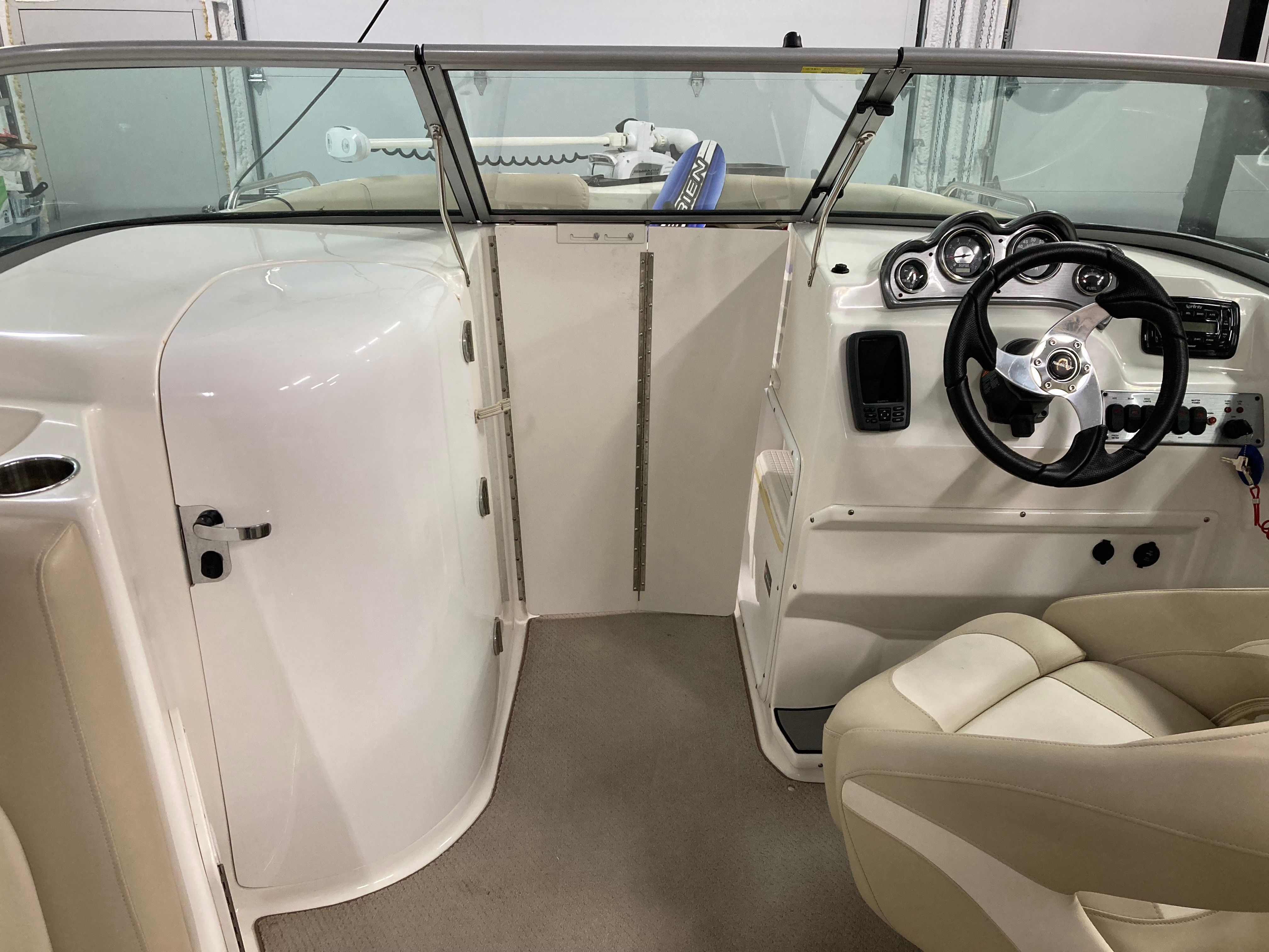 Interior of a 2016 Custom 223 DC boat with steering wheel and dashboard.