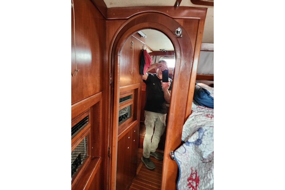 Interior of 1984 Bristol 45.5 Center Cockpit with wooden cabinetry and mirror reflection.