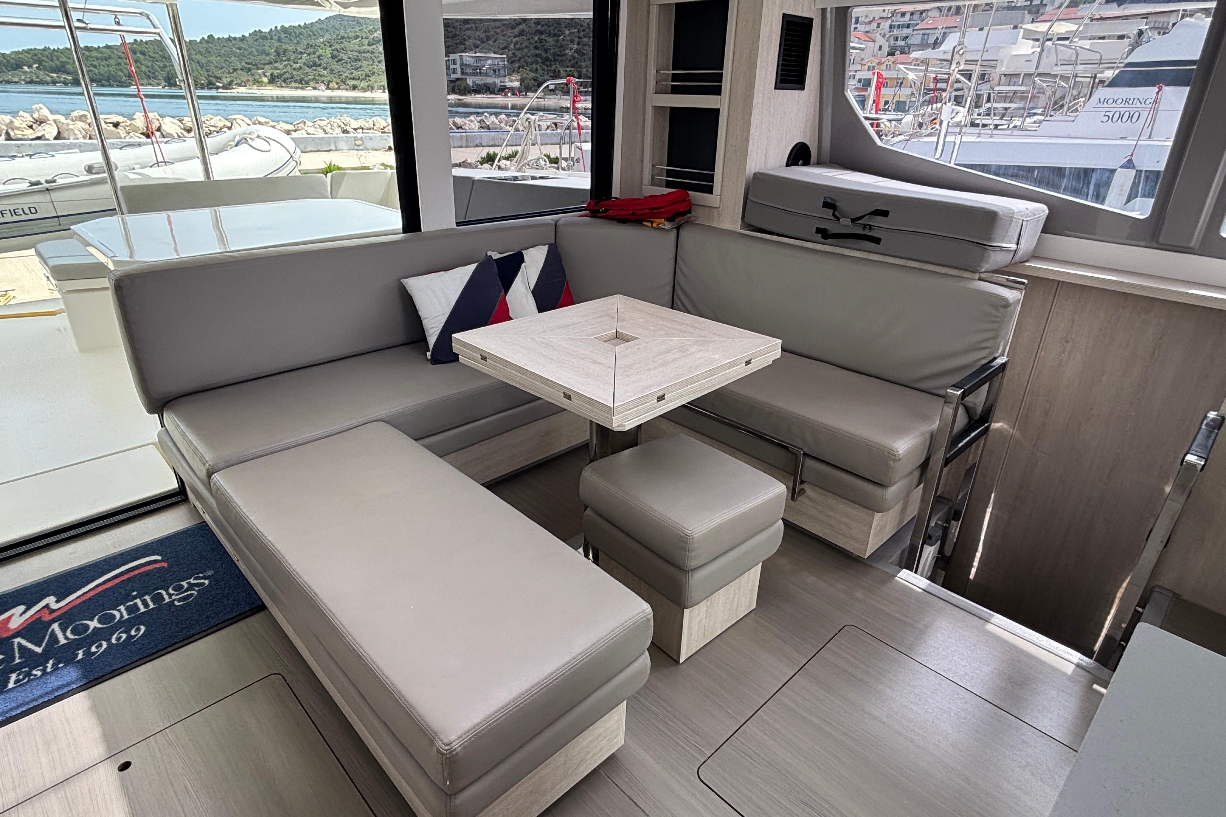 Modern interior of 2020 Leopard 45 yacht with sleek seating and table arrangement.