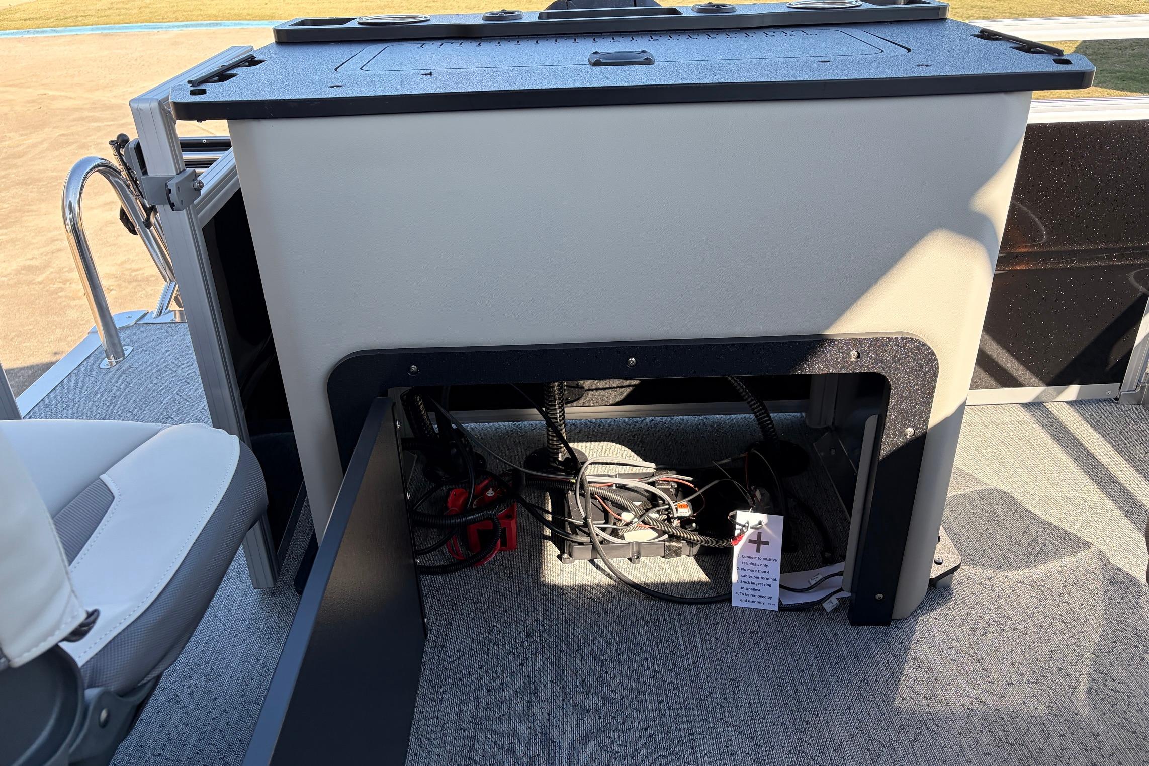 2026 Sun Tracker Fishin' Barge 22 XP3 interior with storage compartment and seating.