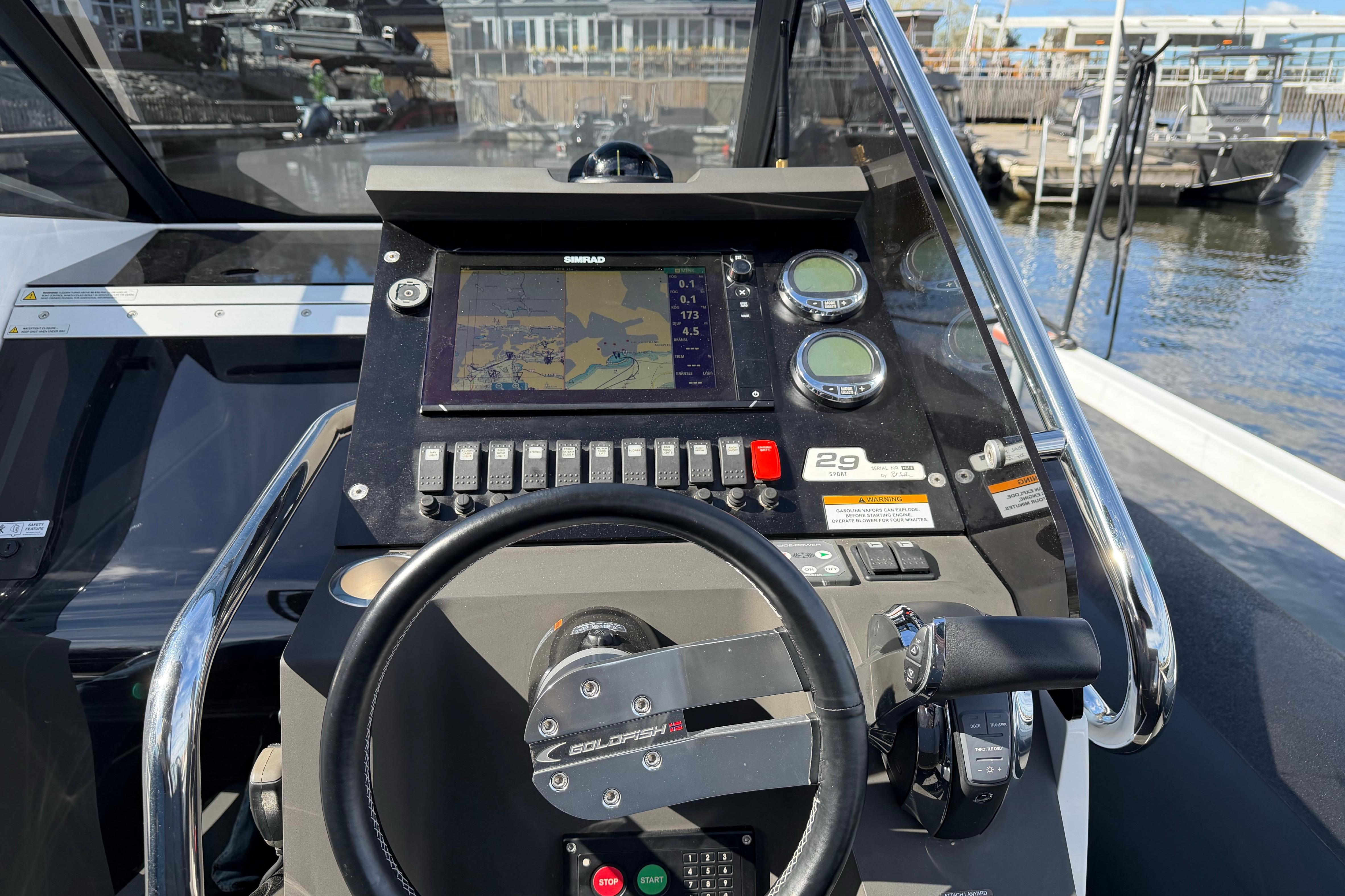 Cockpit of 2016 Goldfish 29 Sport boat with navigation controls and display.