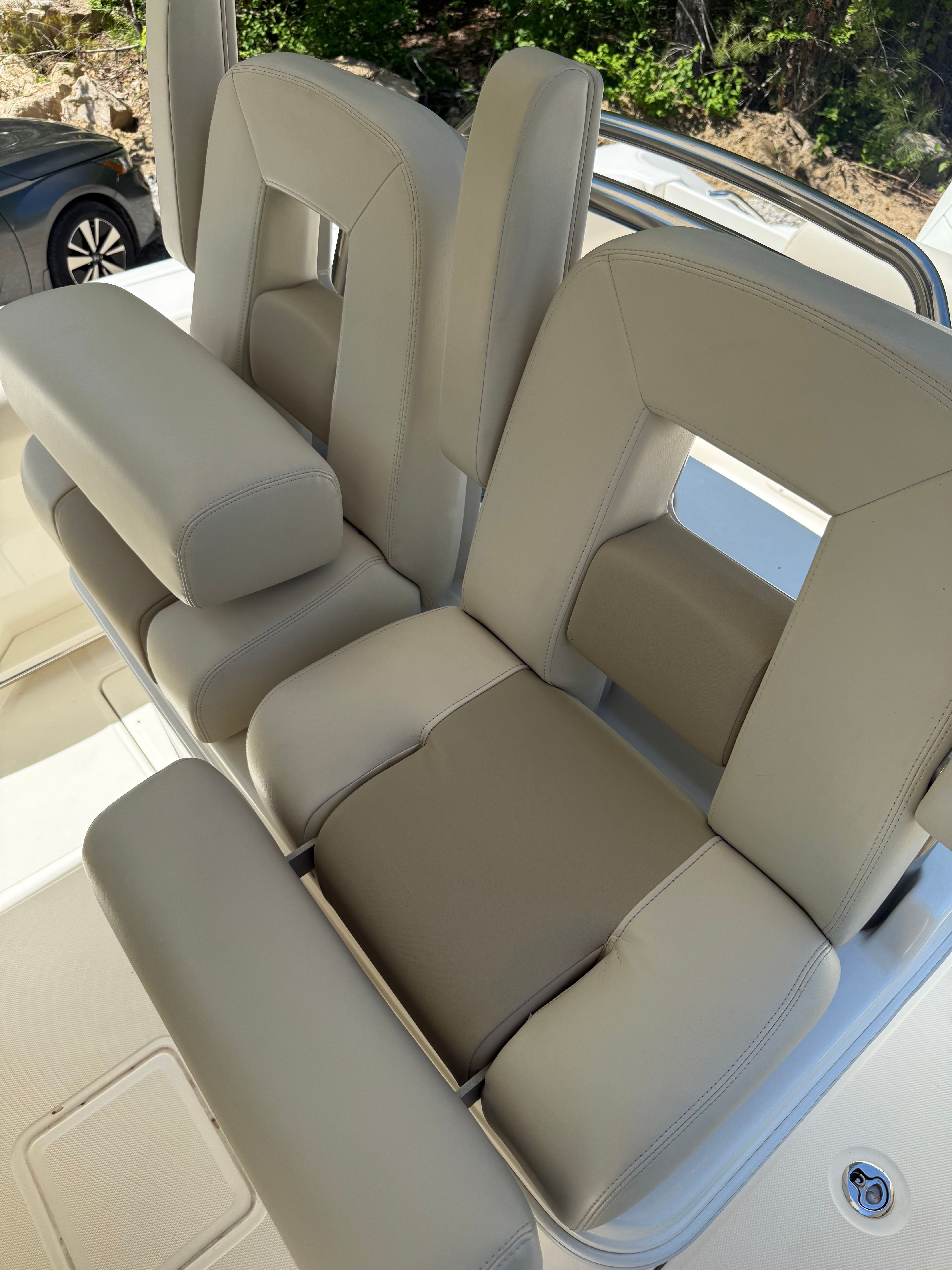 2024 Boston Whaler 250 Outrage, beige cushioned seats on boat.