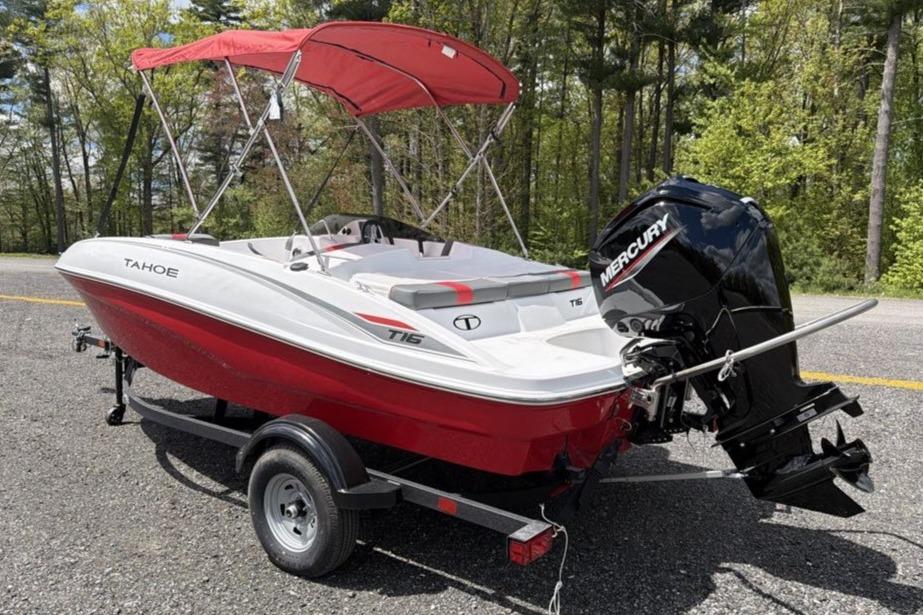 2026 Tahoe T16 boat with Mercury engine on trailer, parked outdoors.