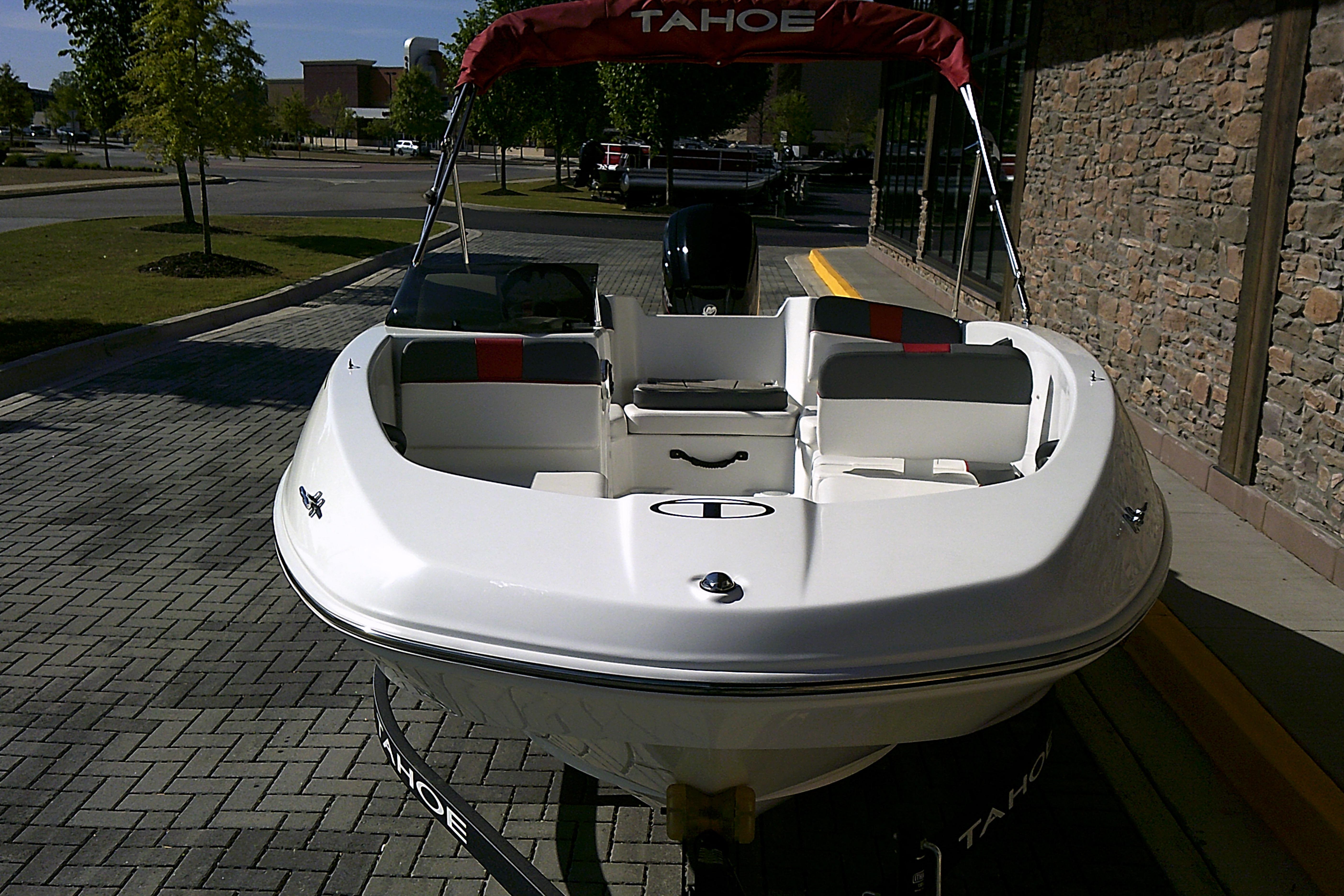2025 Tahoe T16 boat parked on a paved area, featuring sleek white design.