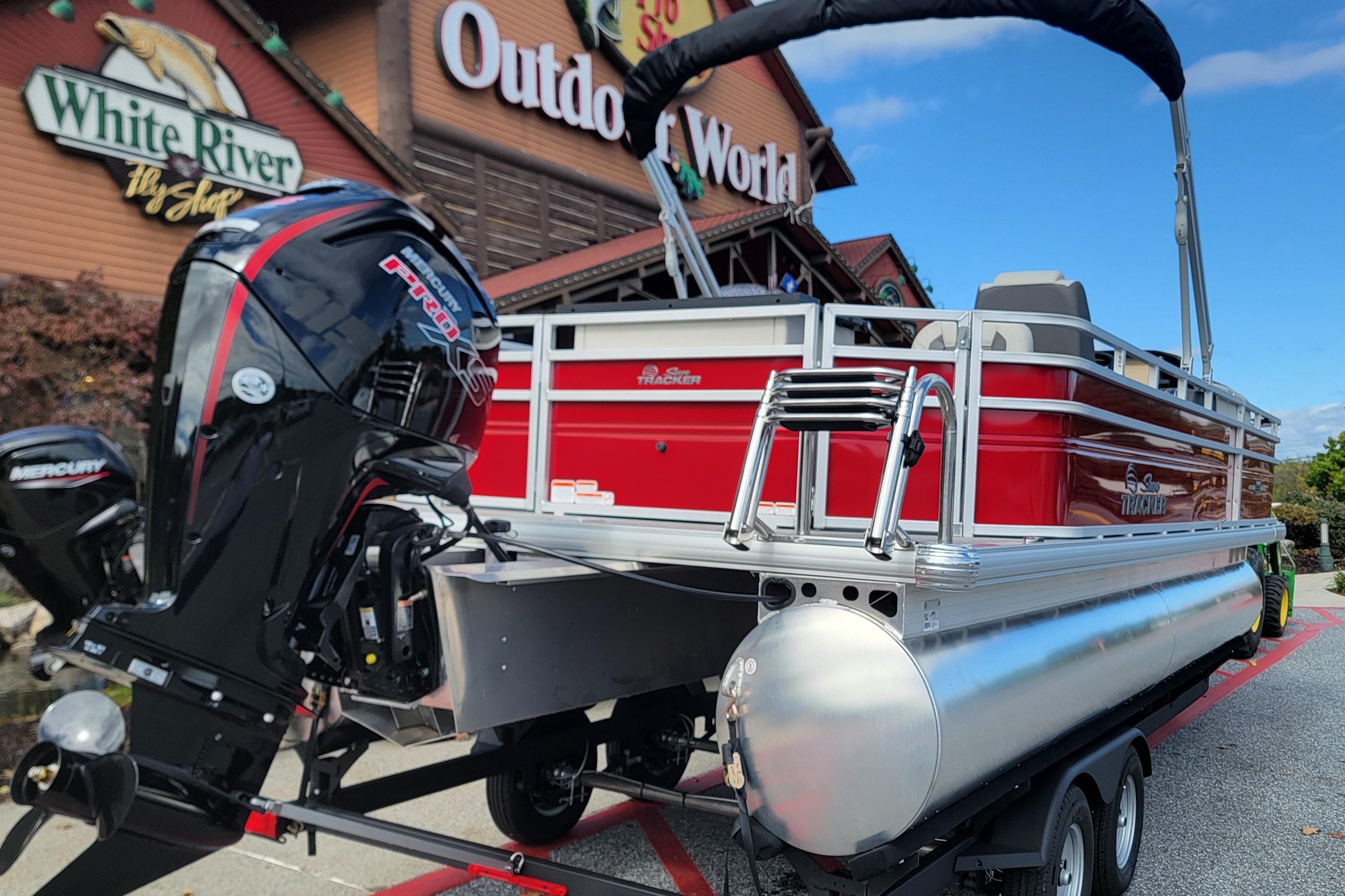 2026 Sun Tracker Fishin' Barge 22 DLX pontoon boat displayed outdoors.