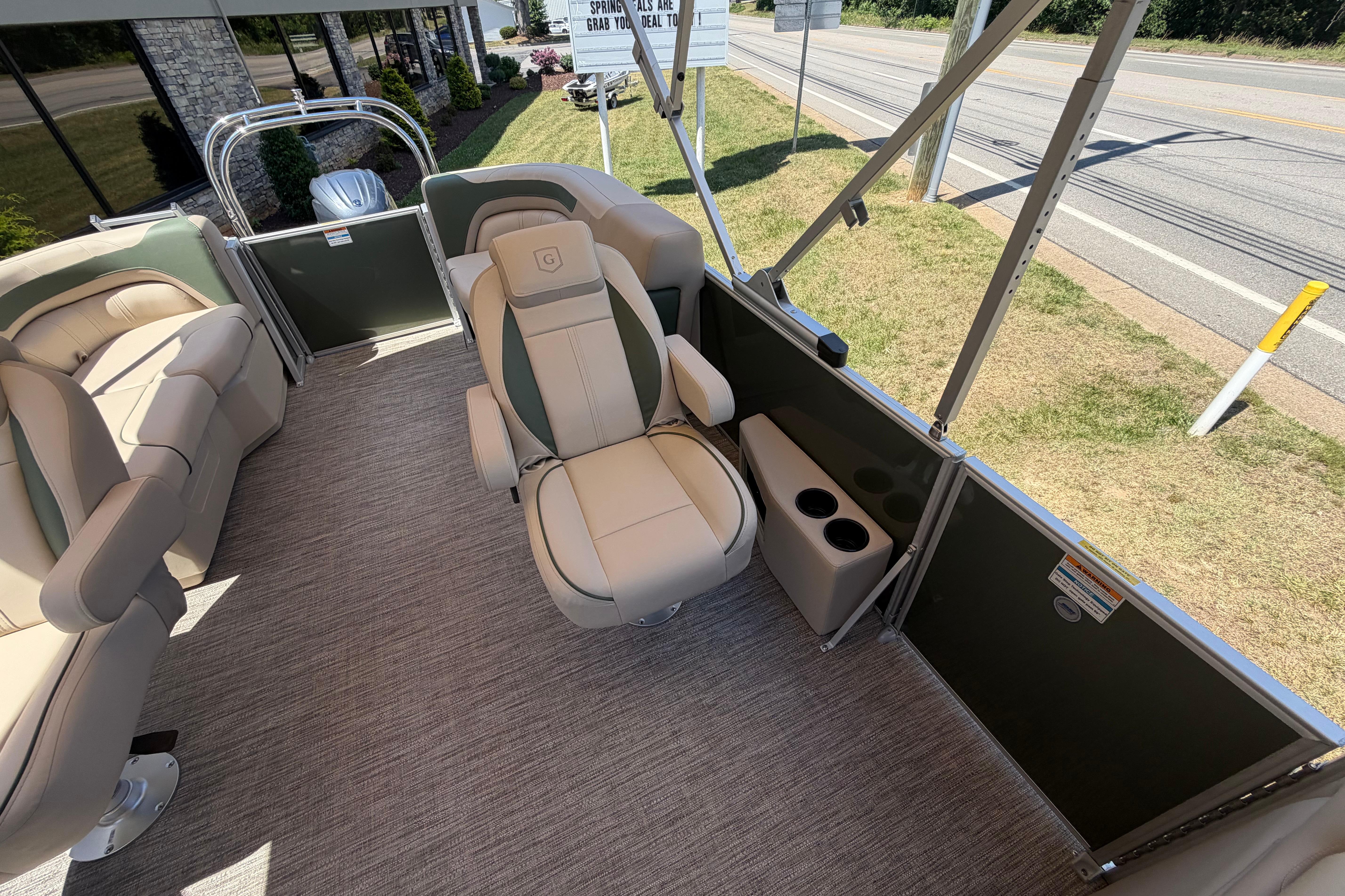 Luxurious seating on 2026 Godfrey SW 2086 SBC pontoon boat, featuring plush captain's chair and cup holders.