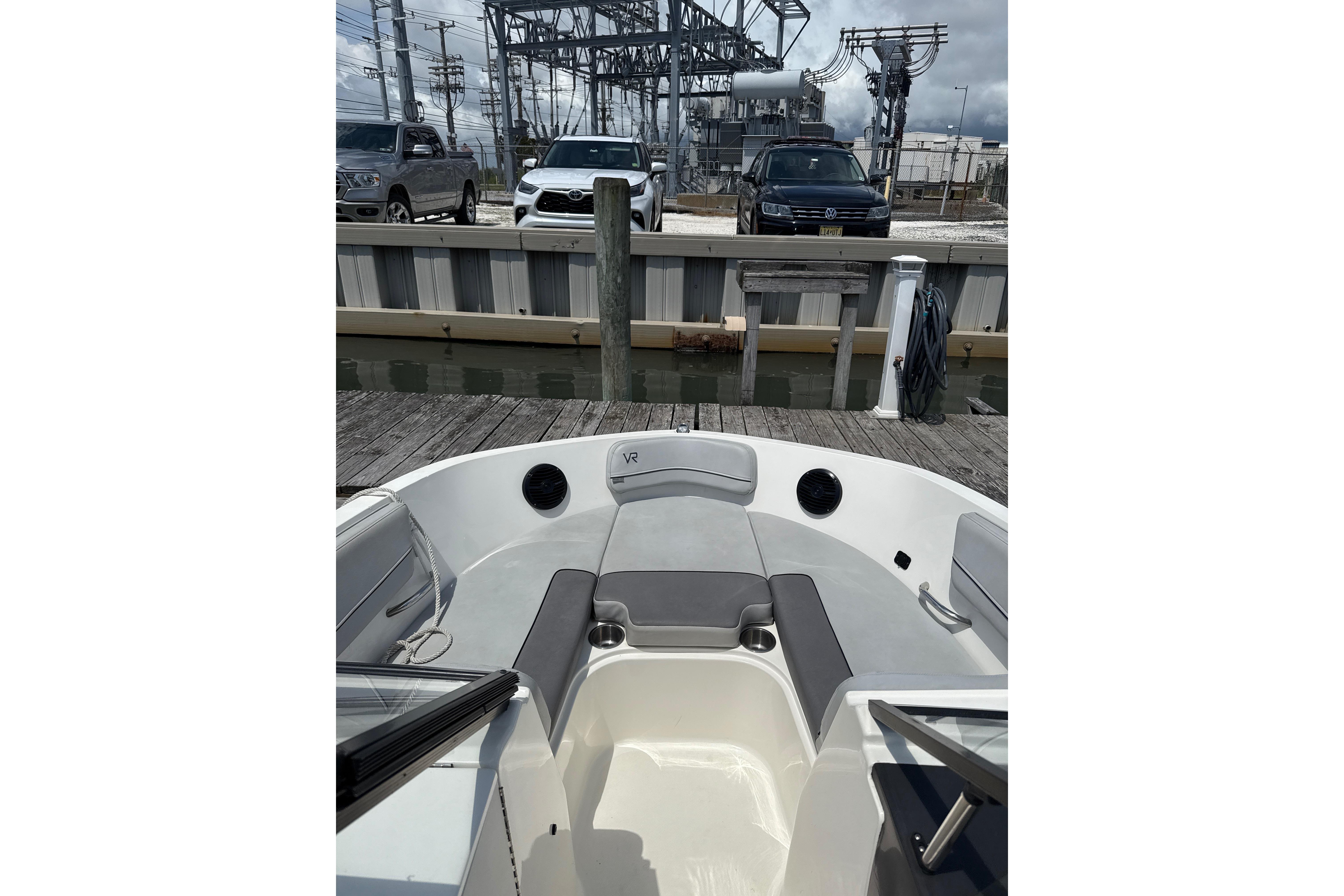 2023 Bayliner VR6 Bowrider OB at dock, featuring spacious seating and modern design.