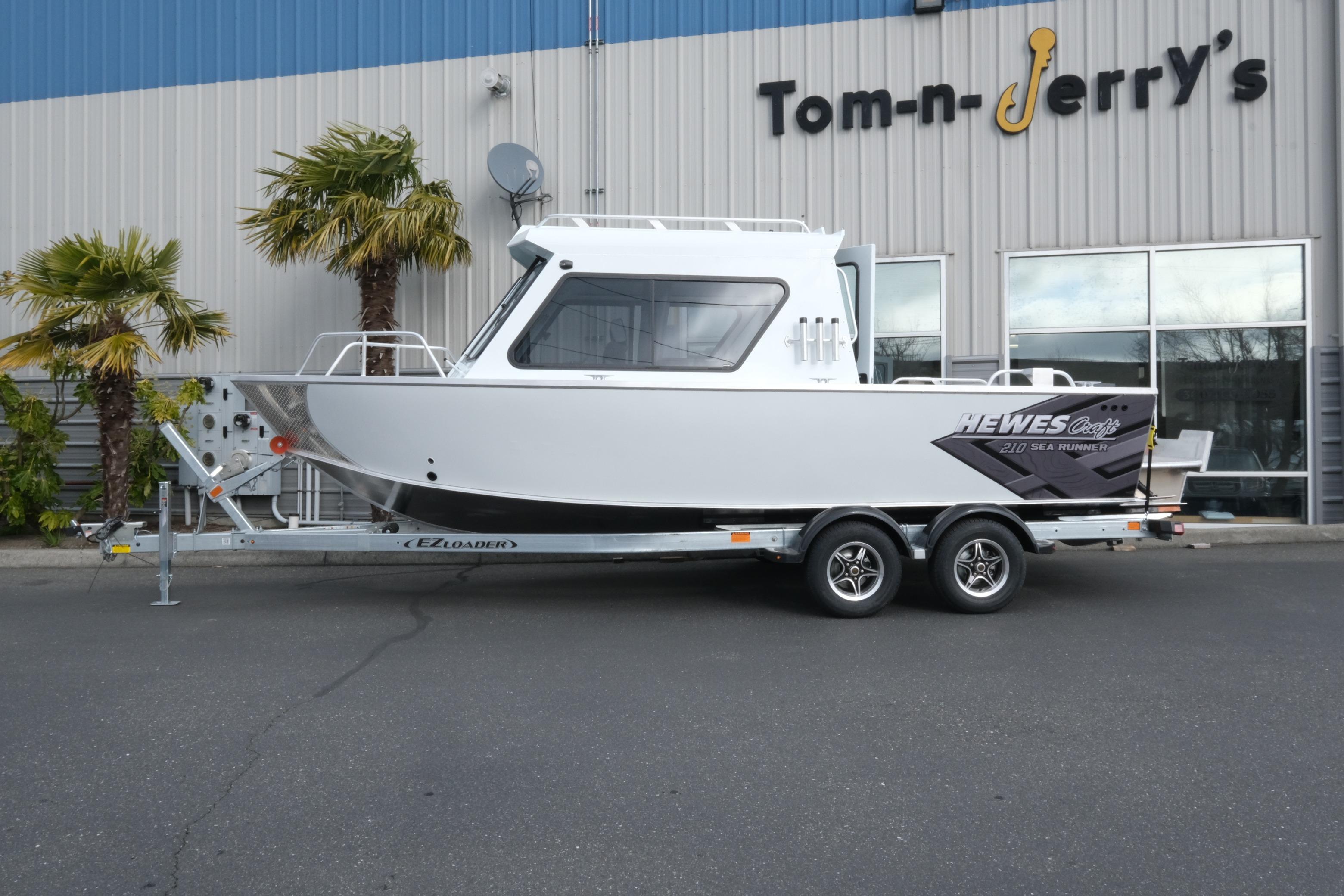 2026 Hewescraft 210 Sea Runner ET Hardtop boat on trailer outside dealership.