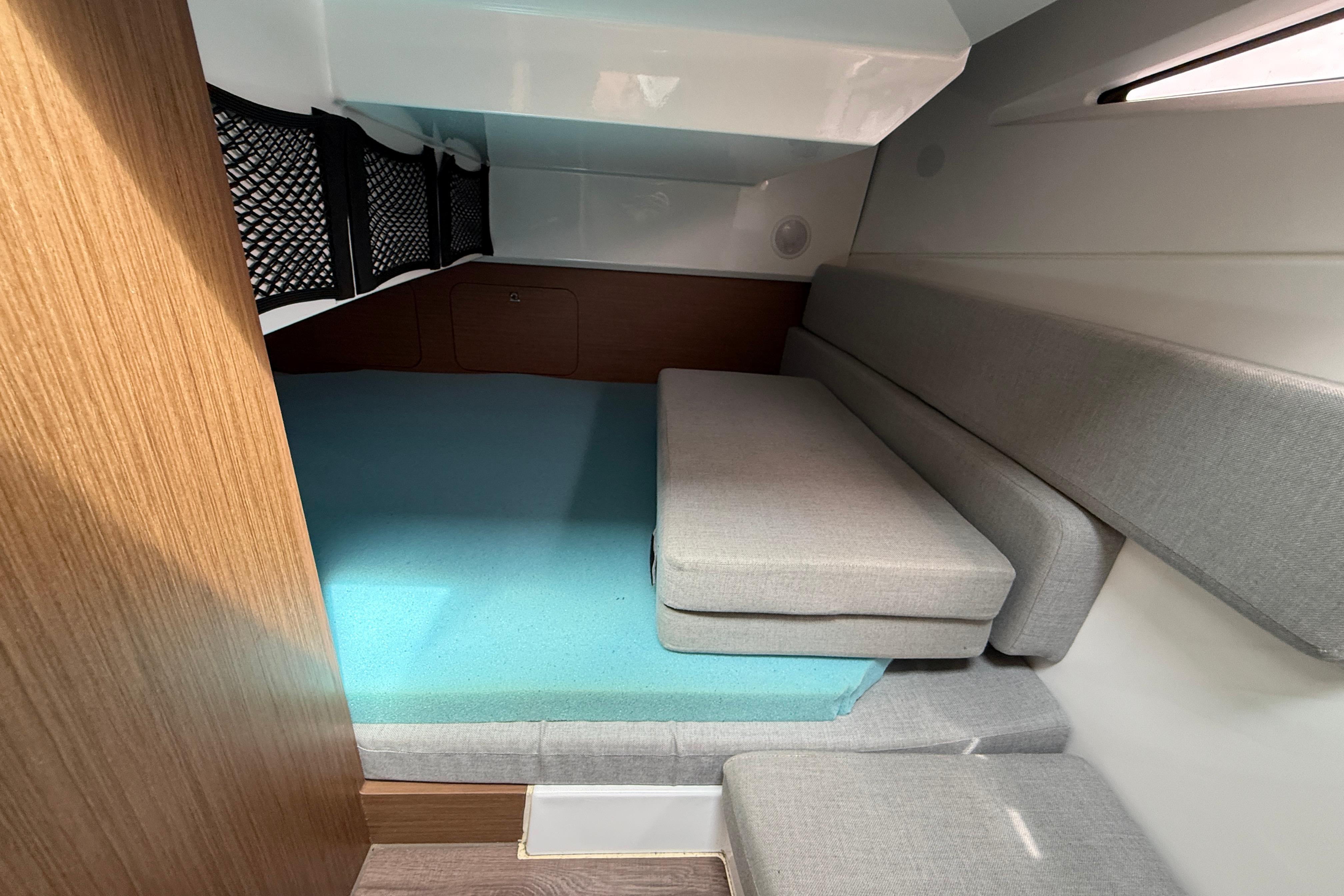 Interior cabin of 2020 Jeanneau NC 895 with cushioned seating and storage.