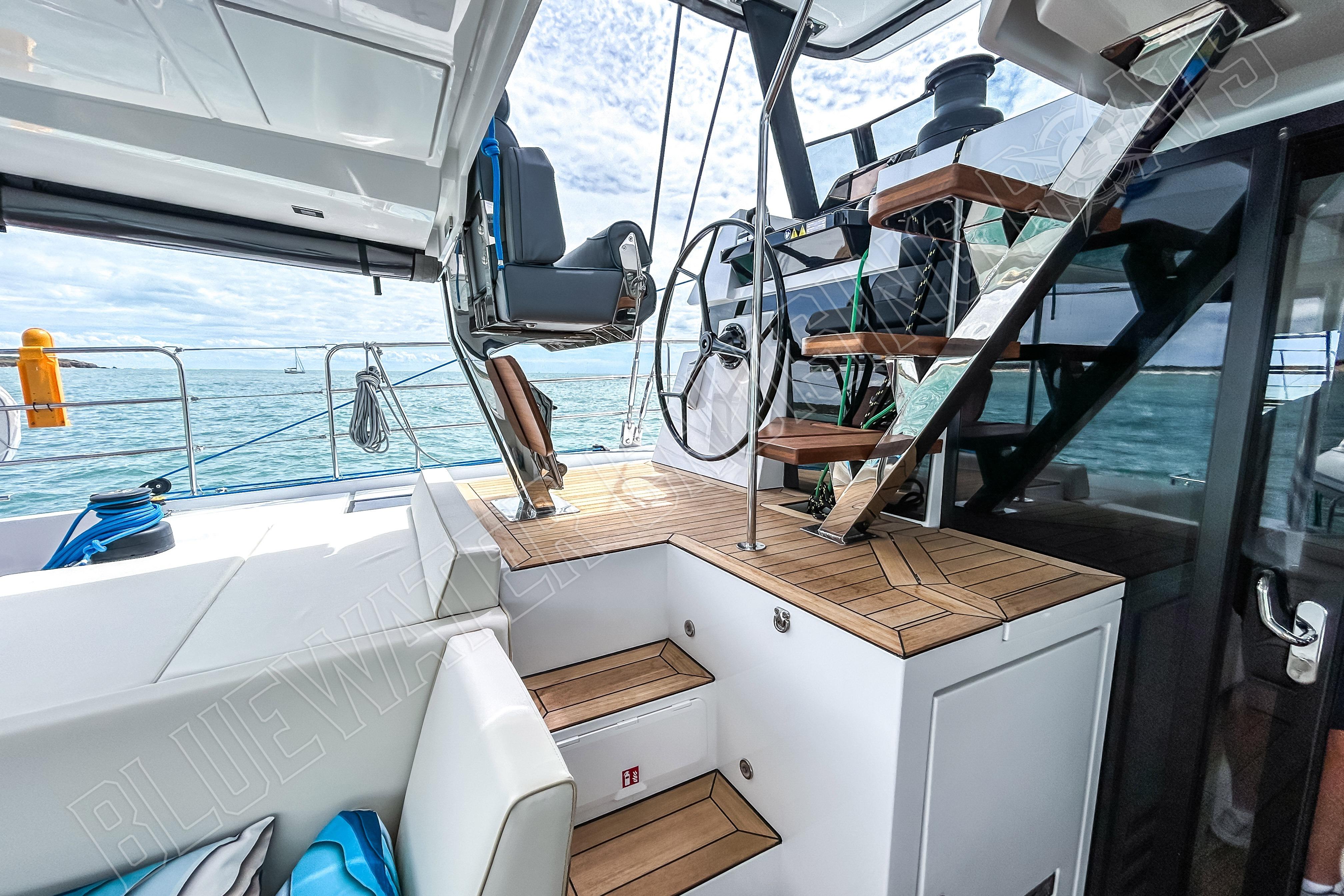Luxurious Privilege 580 yacht interior with modern helm and wooden stairs, 2025 model.