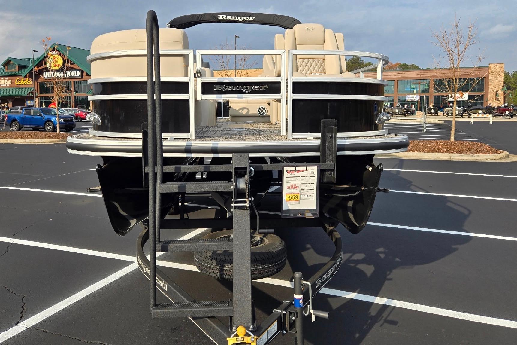 2025 Ranger Reata 223FC pontoon boat on trailer in parking lot.