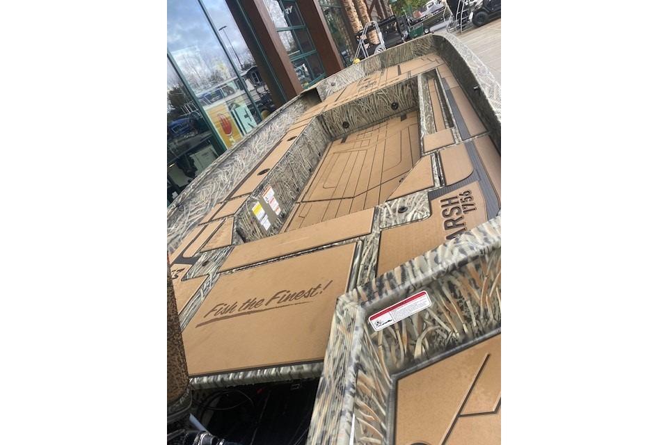 2026 Tracker Grizzly 1756 T Marsh boat with camo design, displayed outdoors.