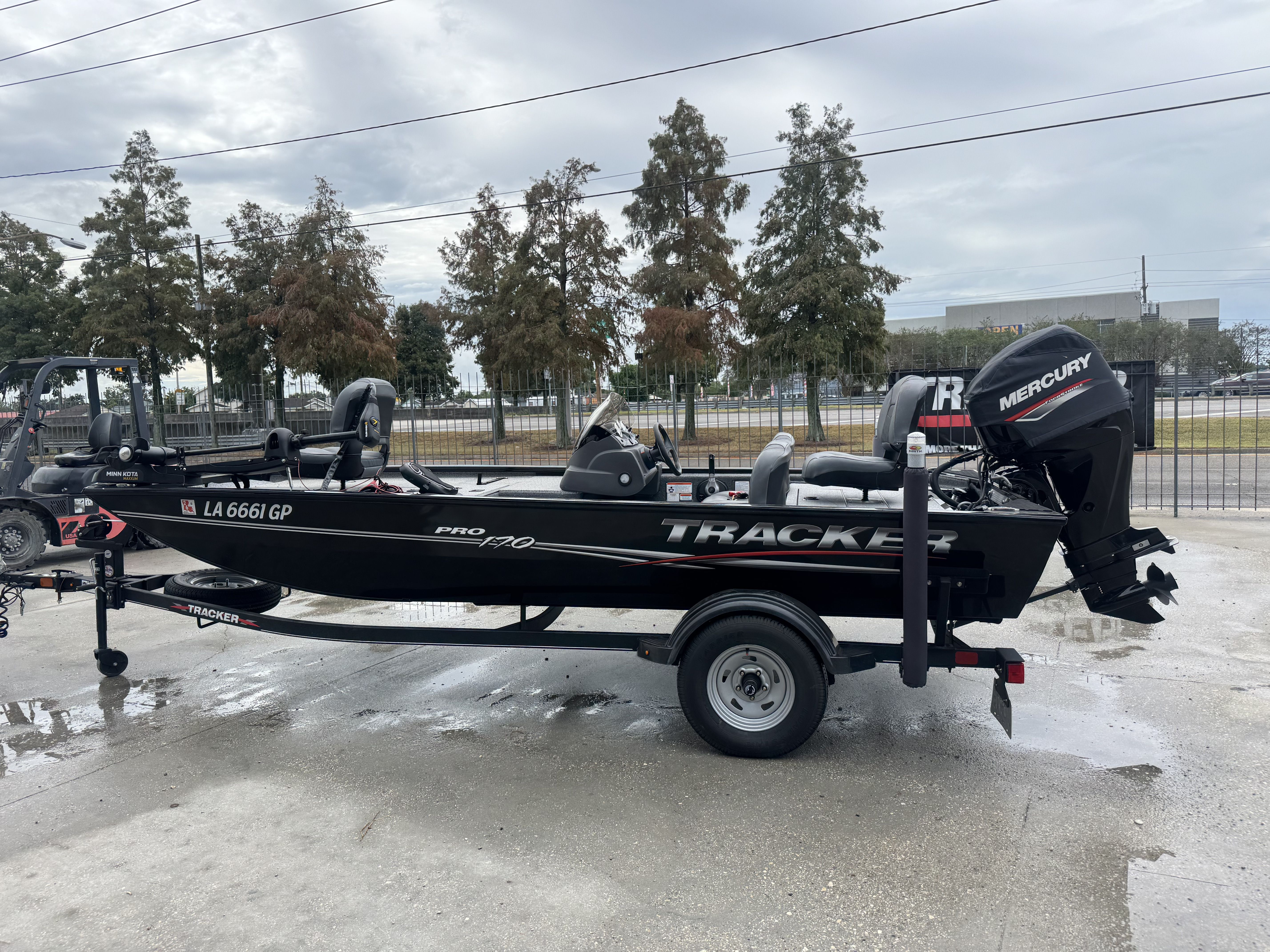 2024 Tracker Pro 170 boat with Mercury engine on trailer, parked outdoors.