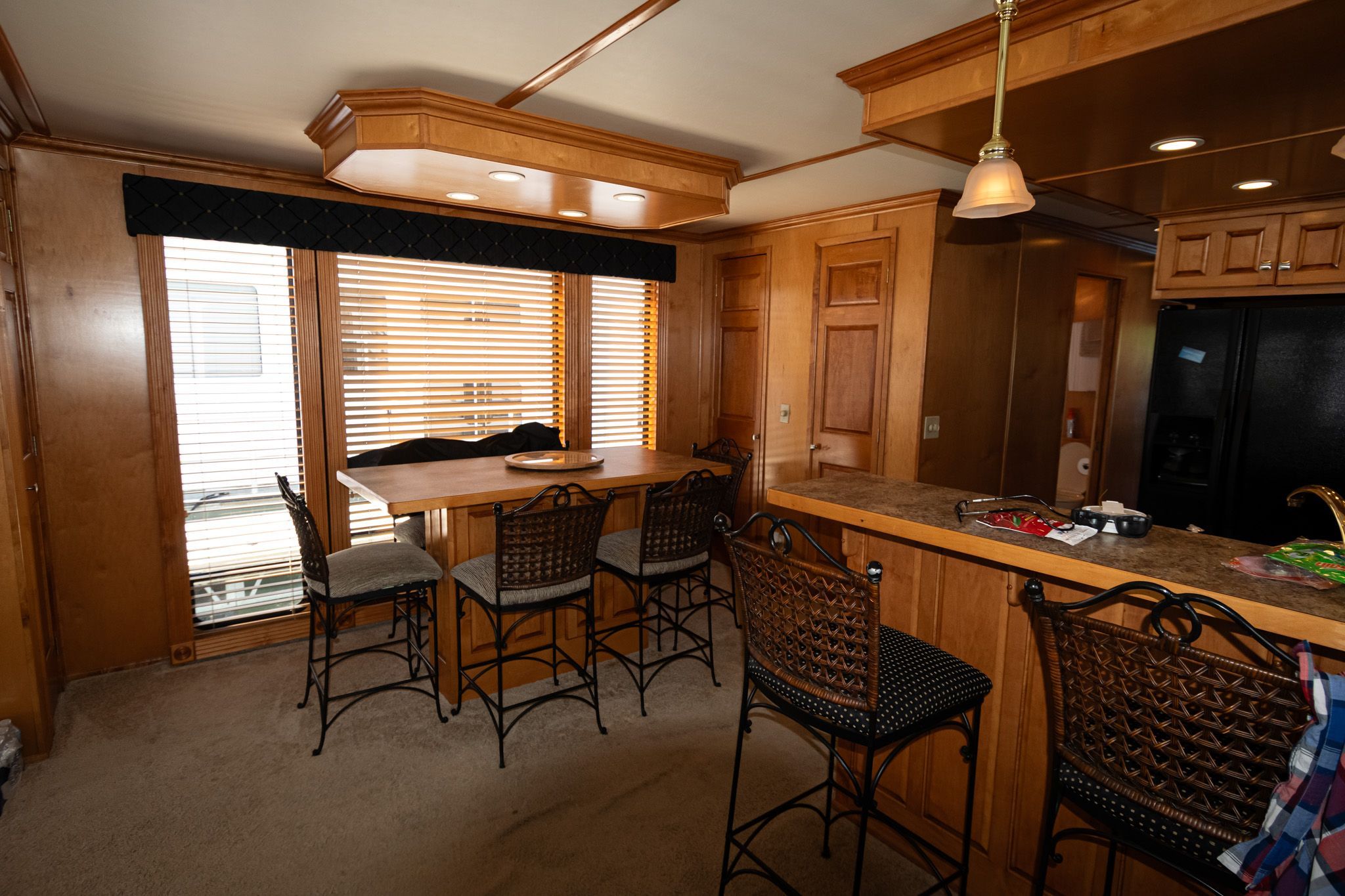 Kitchen in 2003 Lakeview 16x70 houseboat with bar and stools.