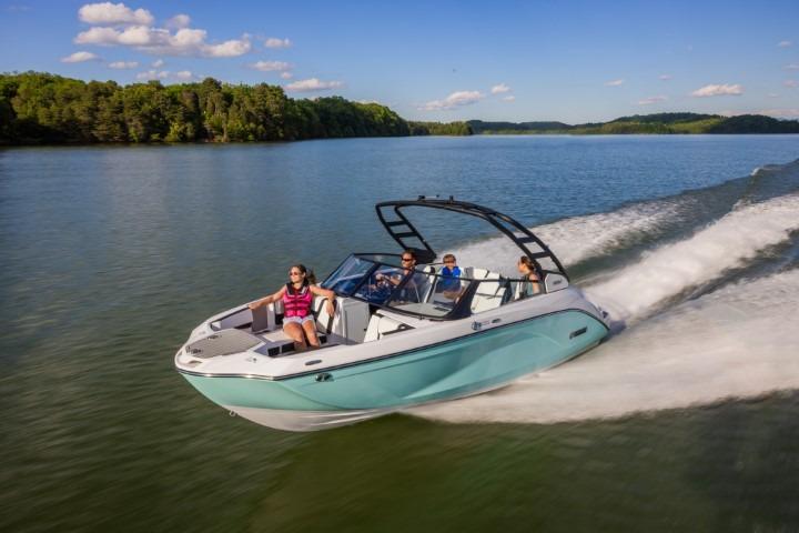 2026 Yamaha Boats 222S cruising on a scenic lake with passengers enjoying the ride.