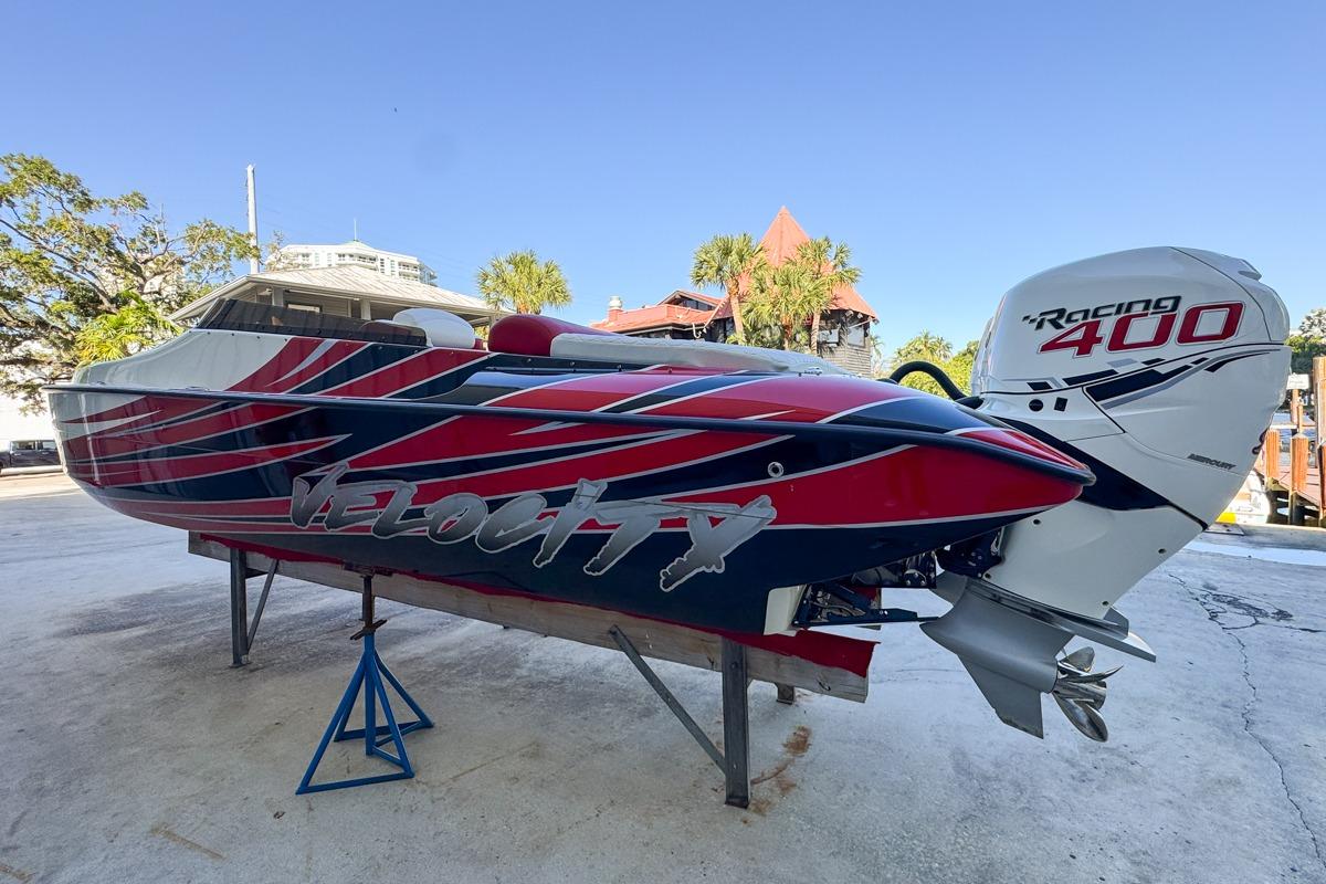 2022 Velocity 290sc speedboat with Racing 400 engine, vibrant red and blue design.