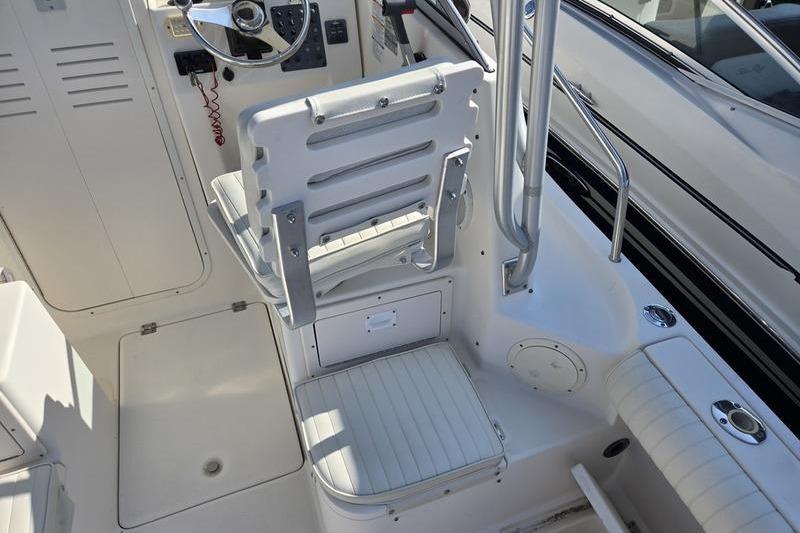 2004 Robalo R235 Walkaround boat cockpit with steering wheel and seating.