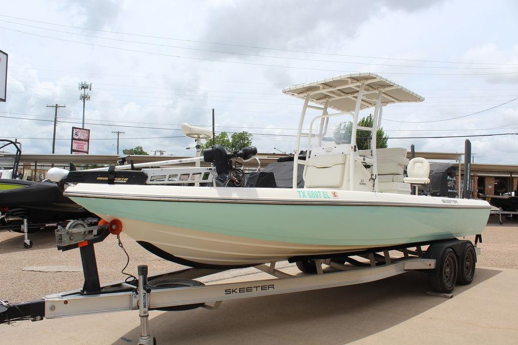 2026 Skeeter SX230 boat on trailer, displayed outdoors under cloudy sky.