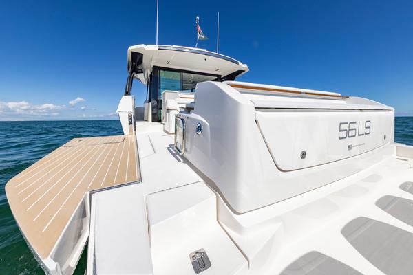 2025 Tiara Yachts 56 LS luxury yacht on open sea, showcasing sleek design and spacious deck.