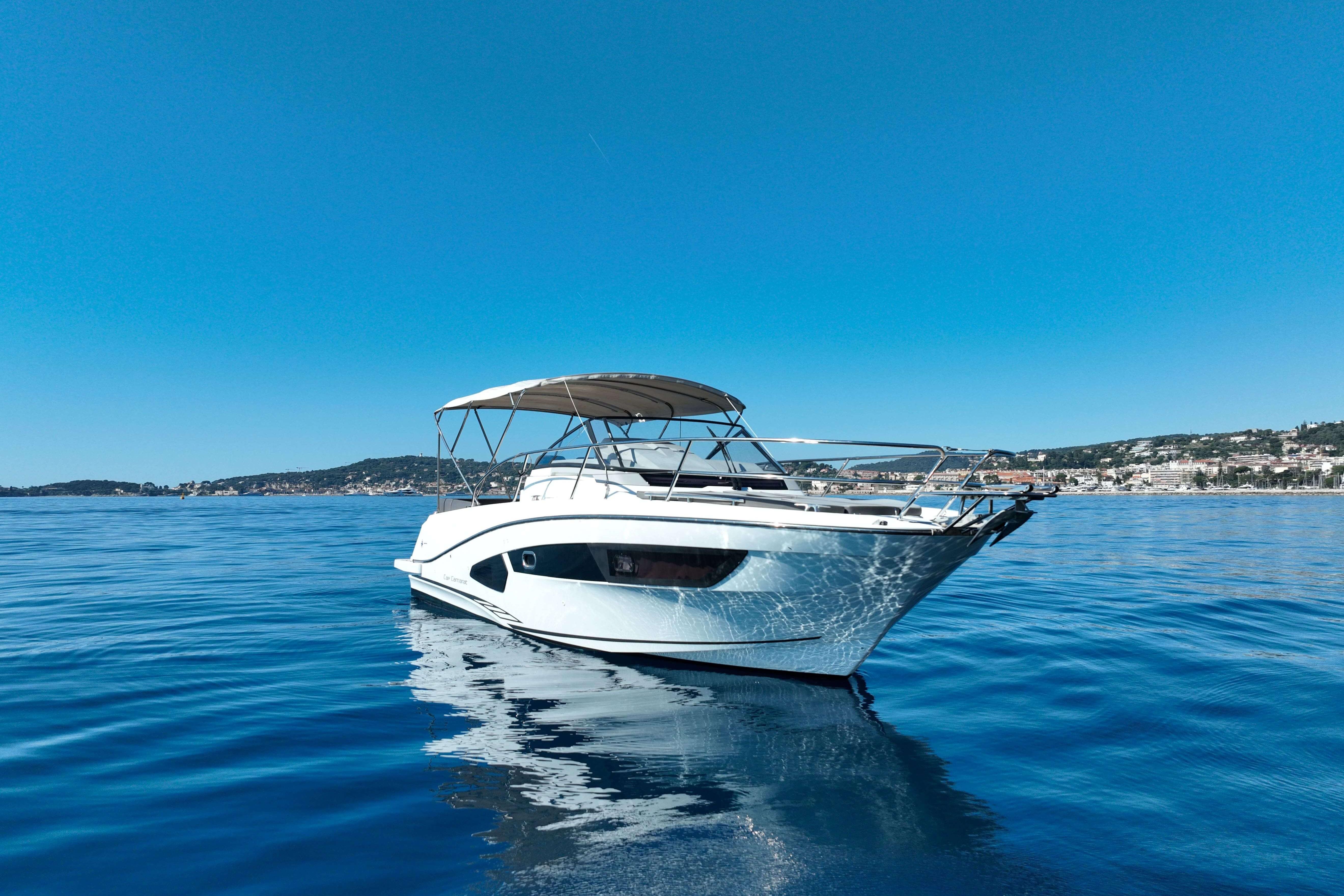 2018 Cap Camarat 10.5 WA boat on calm blue water, coastal background.