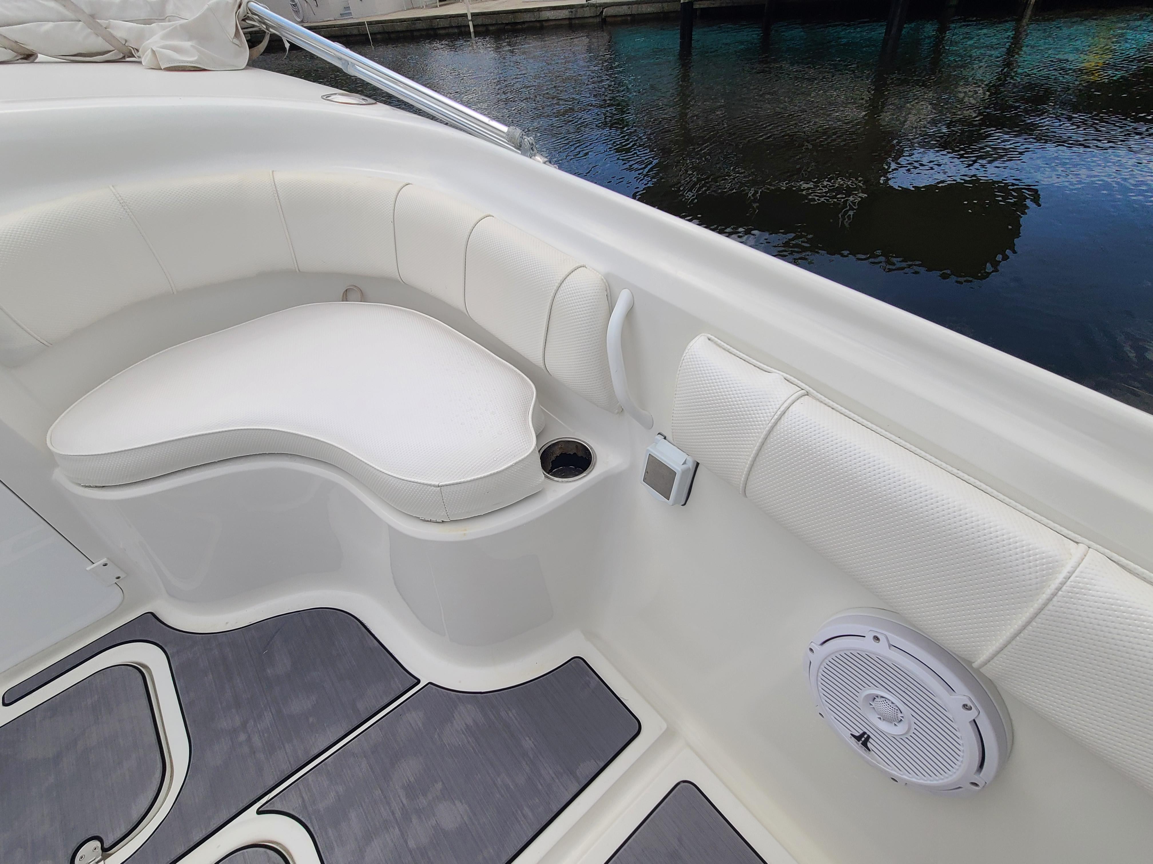 2009 Glasstream 360 SCX boat interior with white cushioned seating and cup holder.