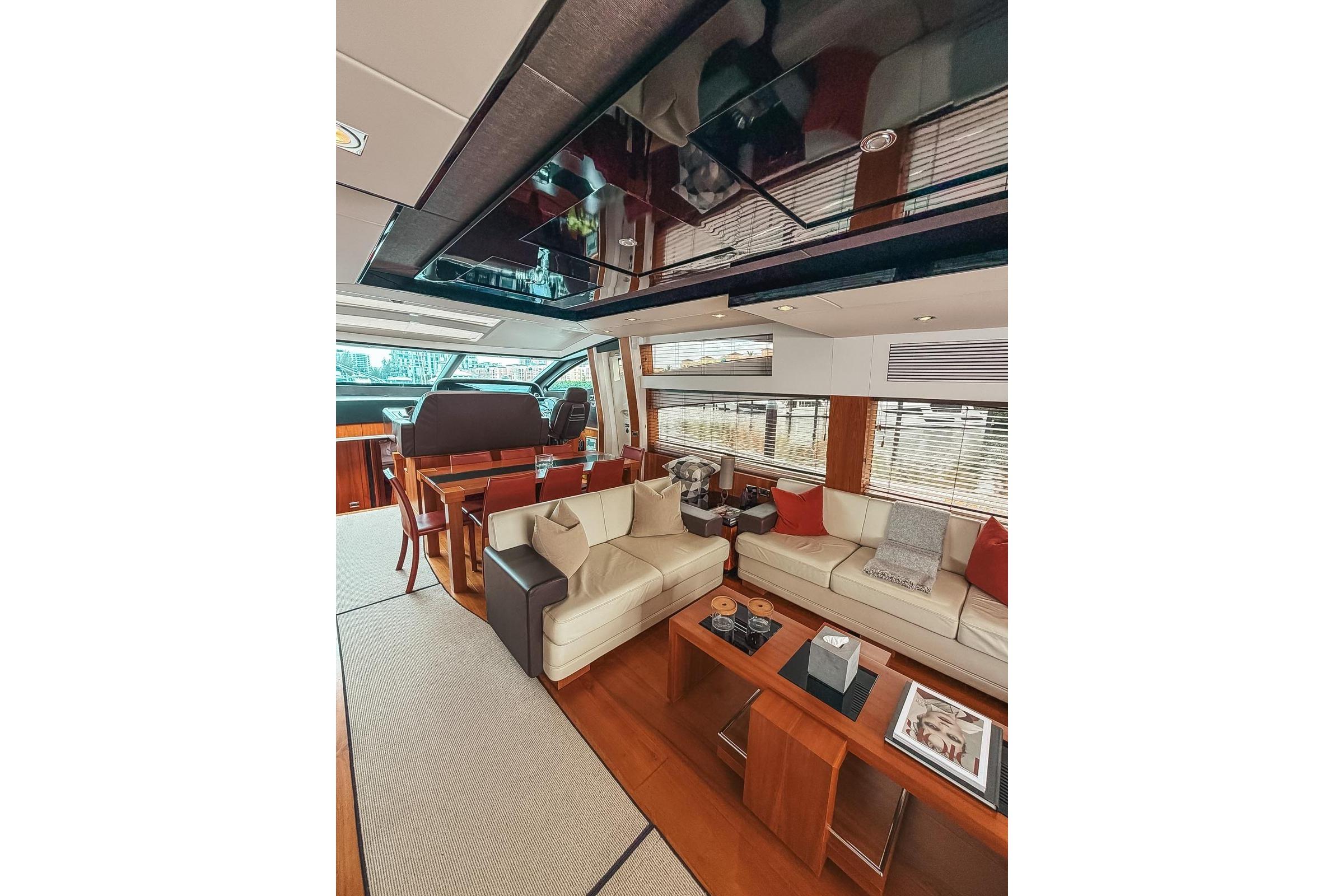 Luxurious interior of 2010 Sunseeker Predator 84 yacht with elegant seating and dining area.