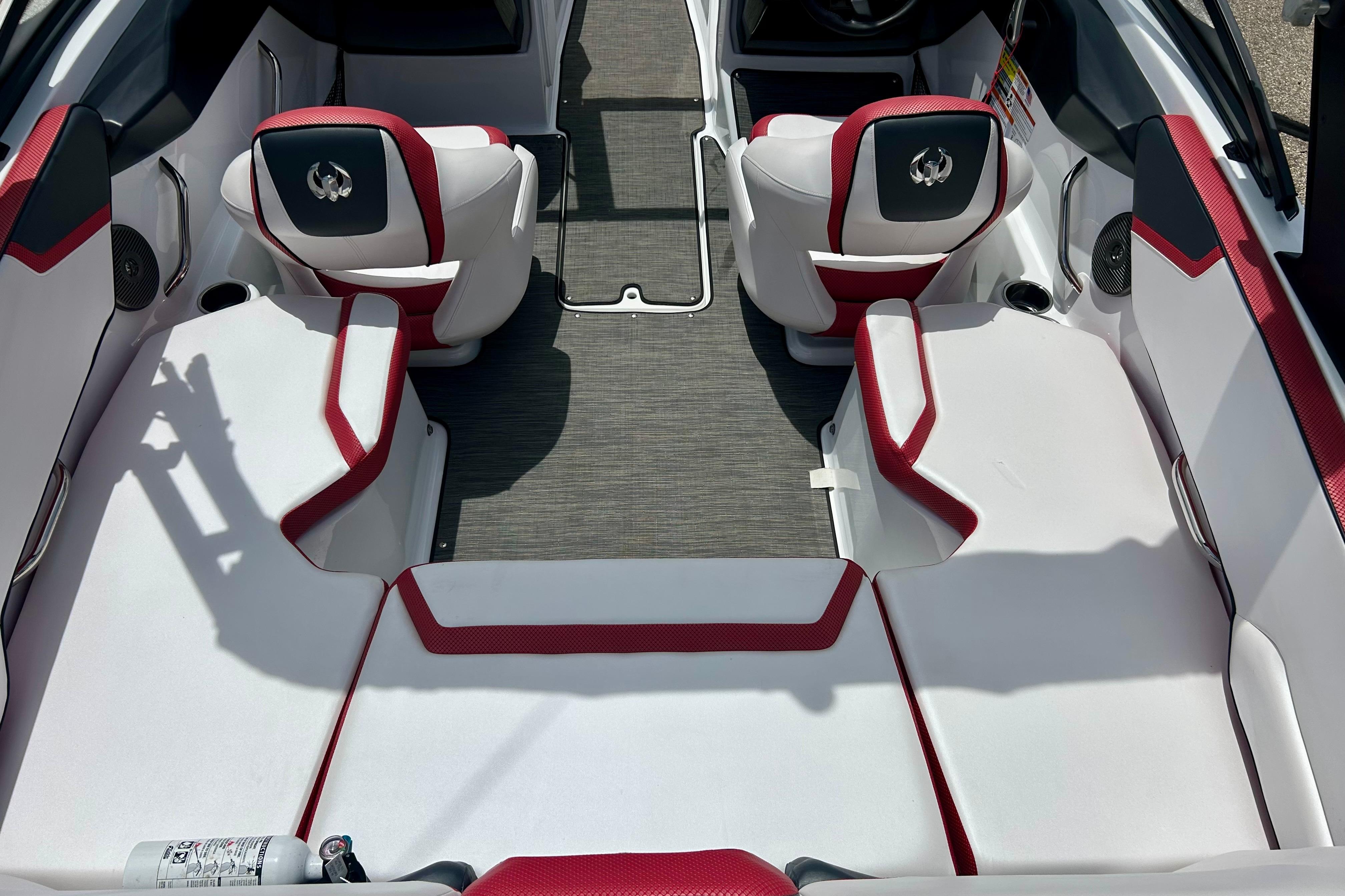 Interior of 2021 Scarab 195 ID boat with red and white seating.