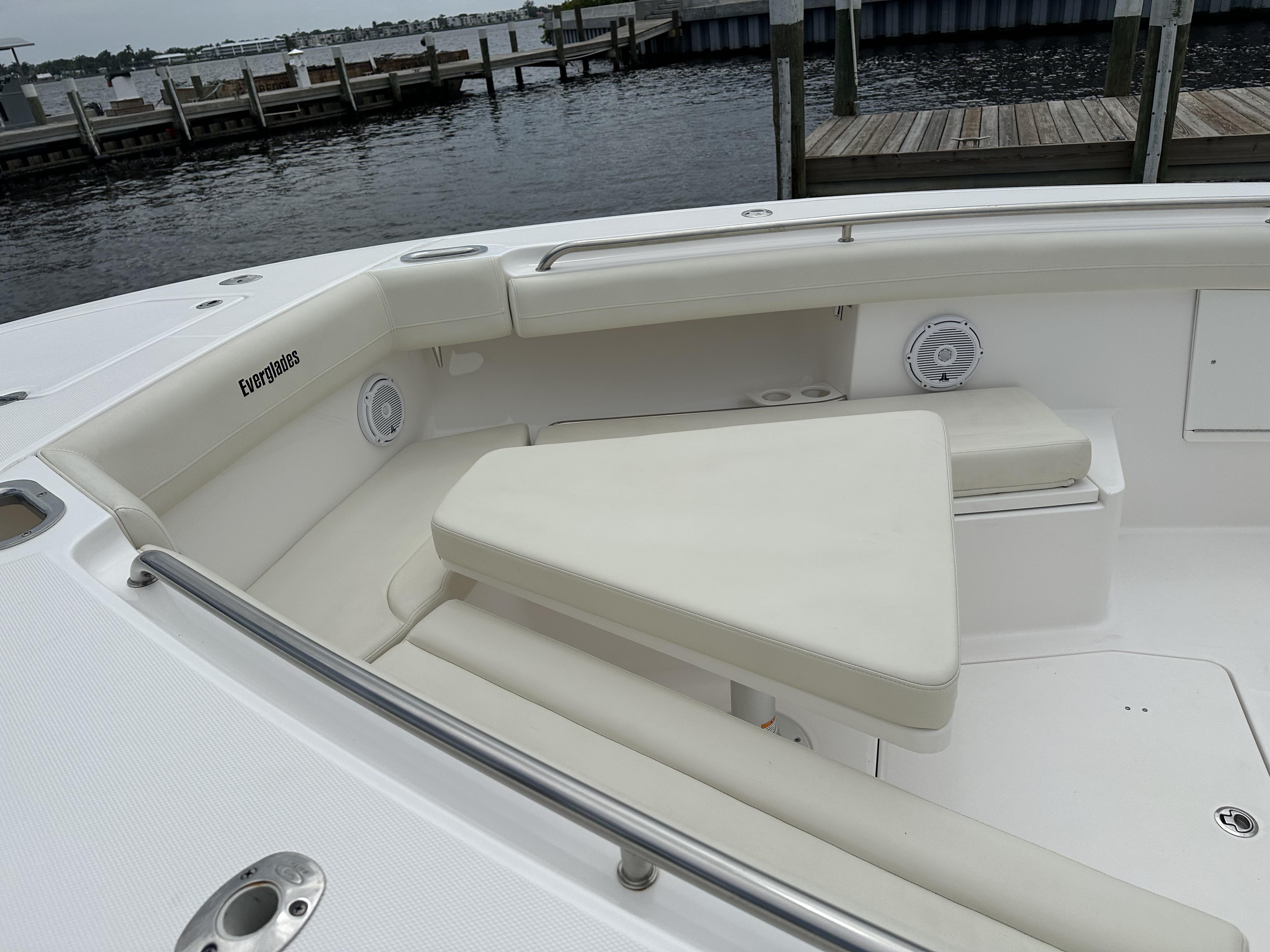 2017 Everglades 435 Center Console boat with white seating, docked by the water.