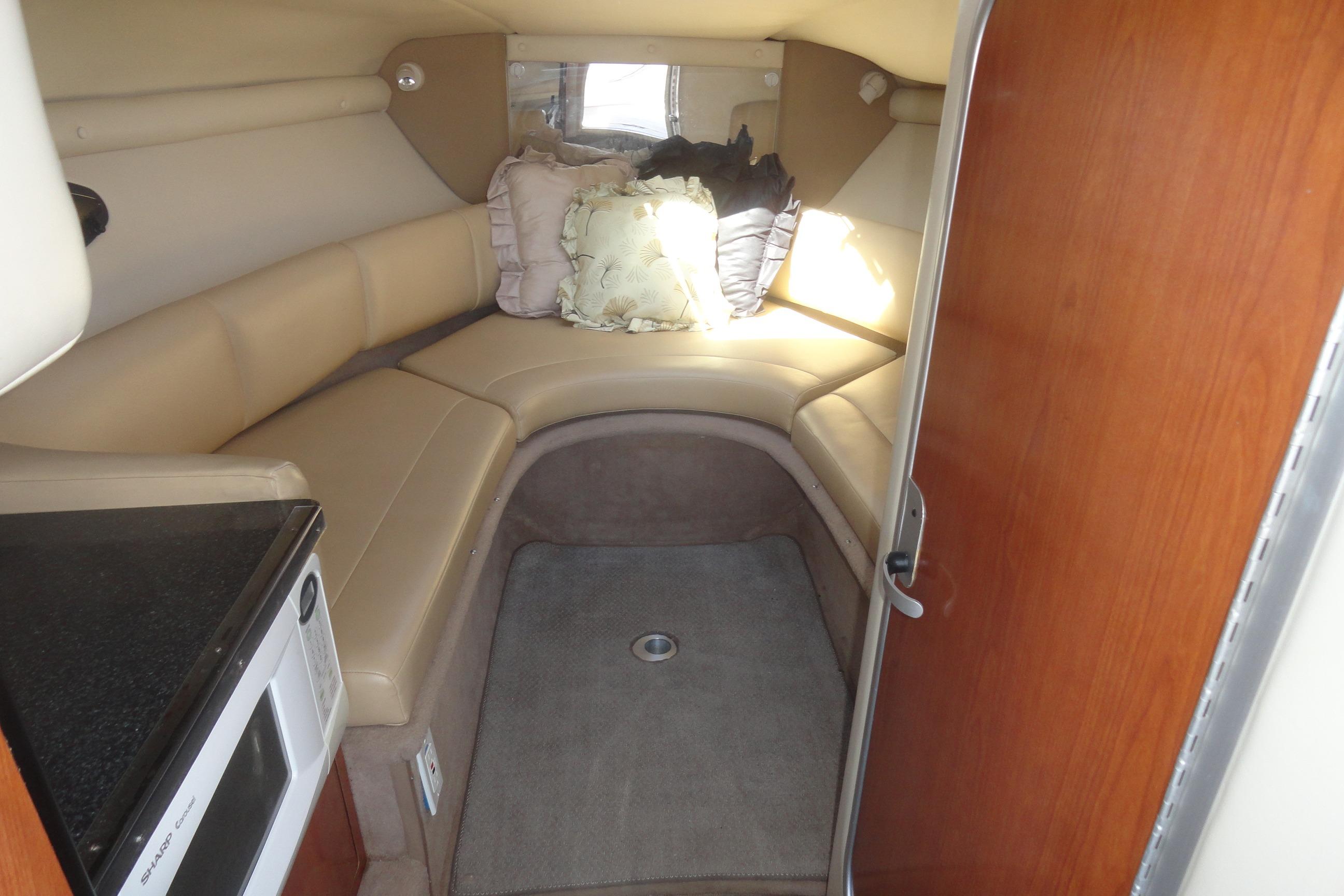 Interior cabin of 2001 Chaparral 265 SSi boat with seating and microwave.