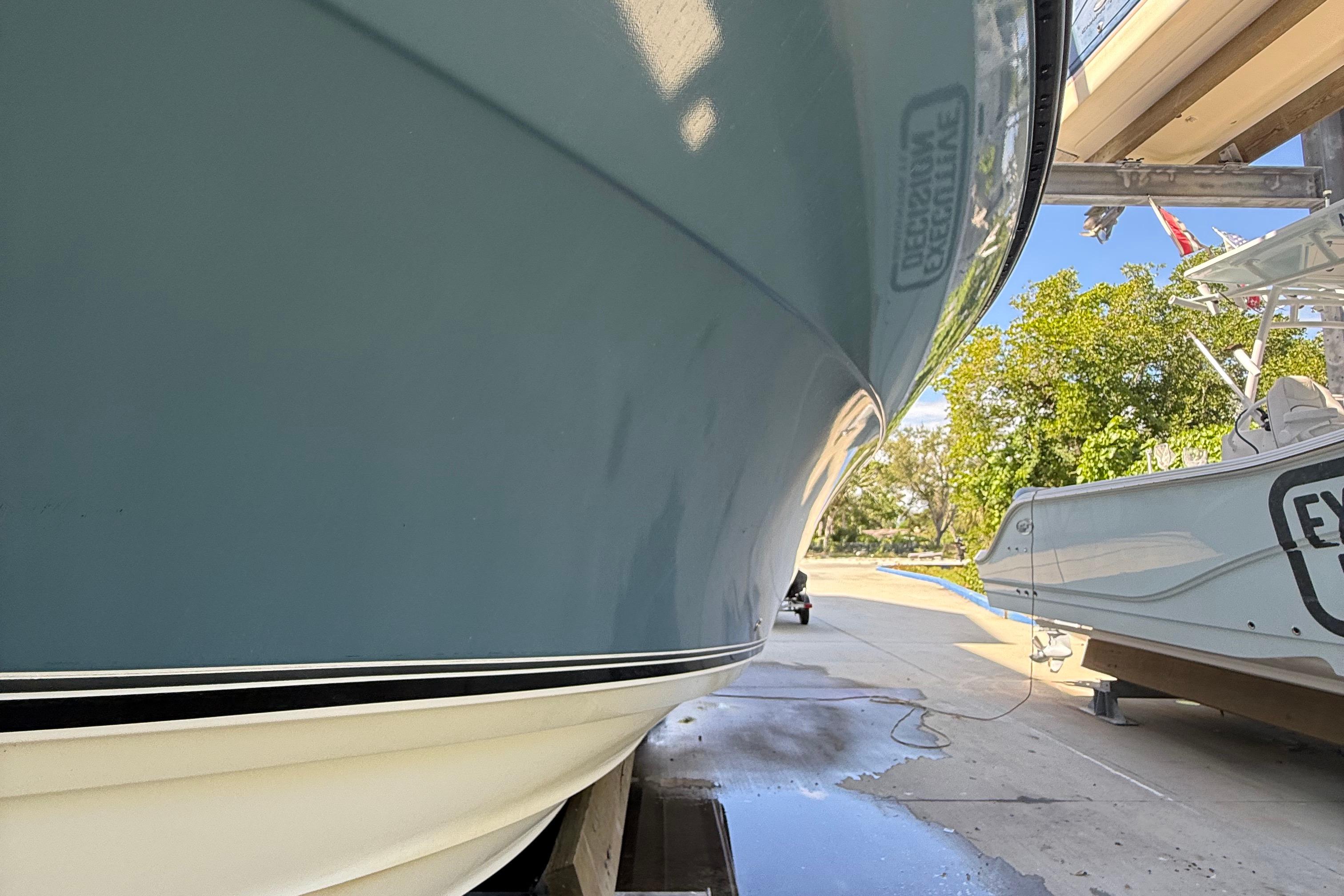 2008 Century 2901 Center Console boat on a trailer, side view, outdoors.