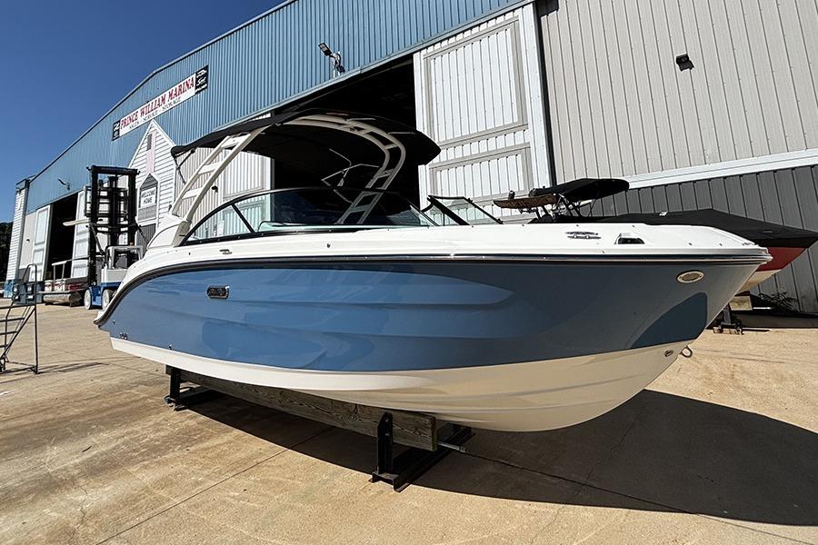2027 Sea Ray SDX 230 Outboard boat in marina, blue and white exterior.