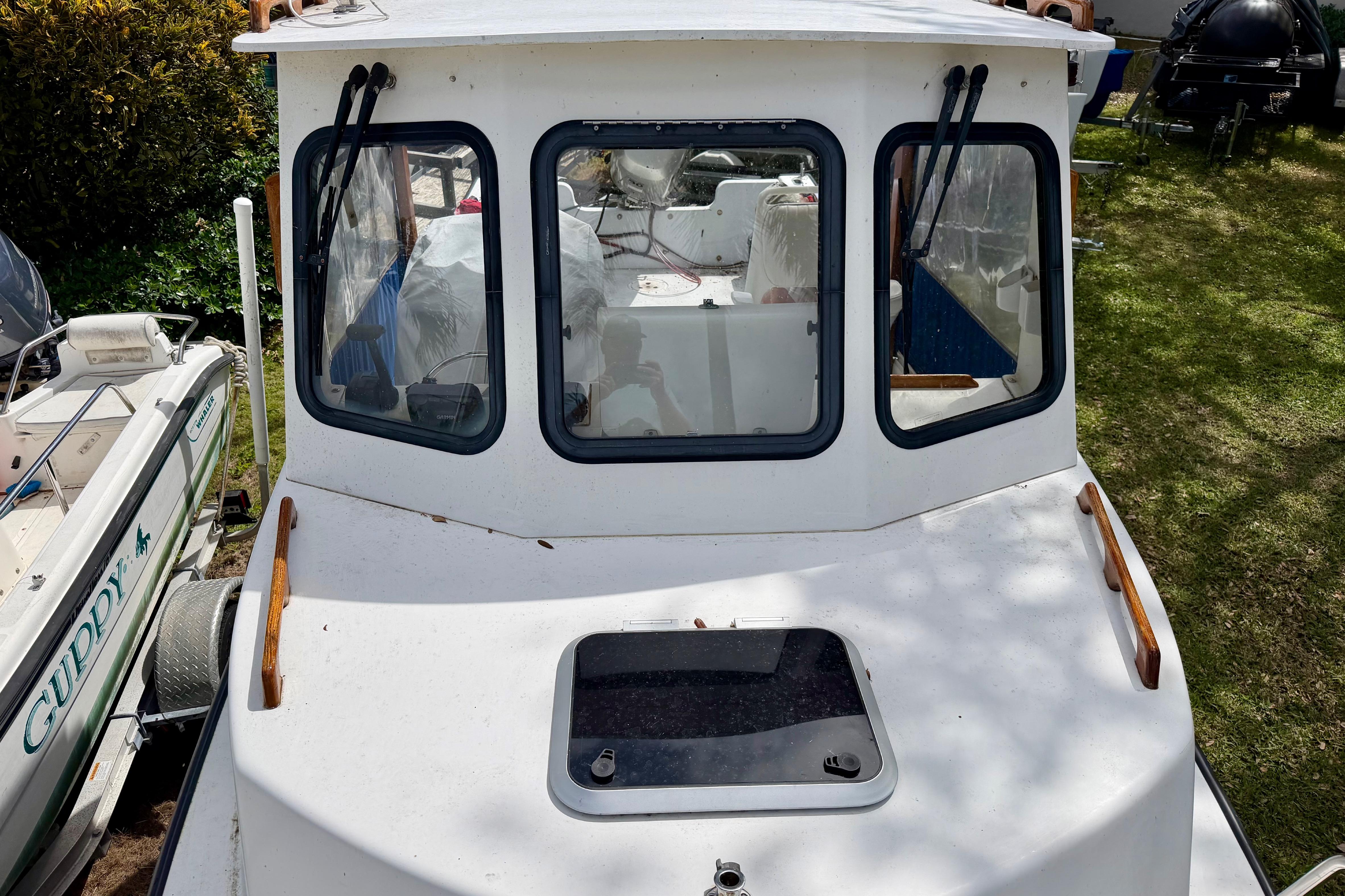 2000 Eastern 22 Lobster Fisherman boat with cabin, docked on grass.