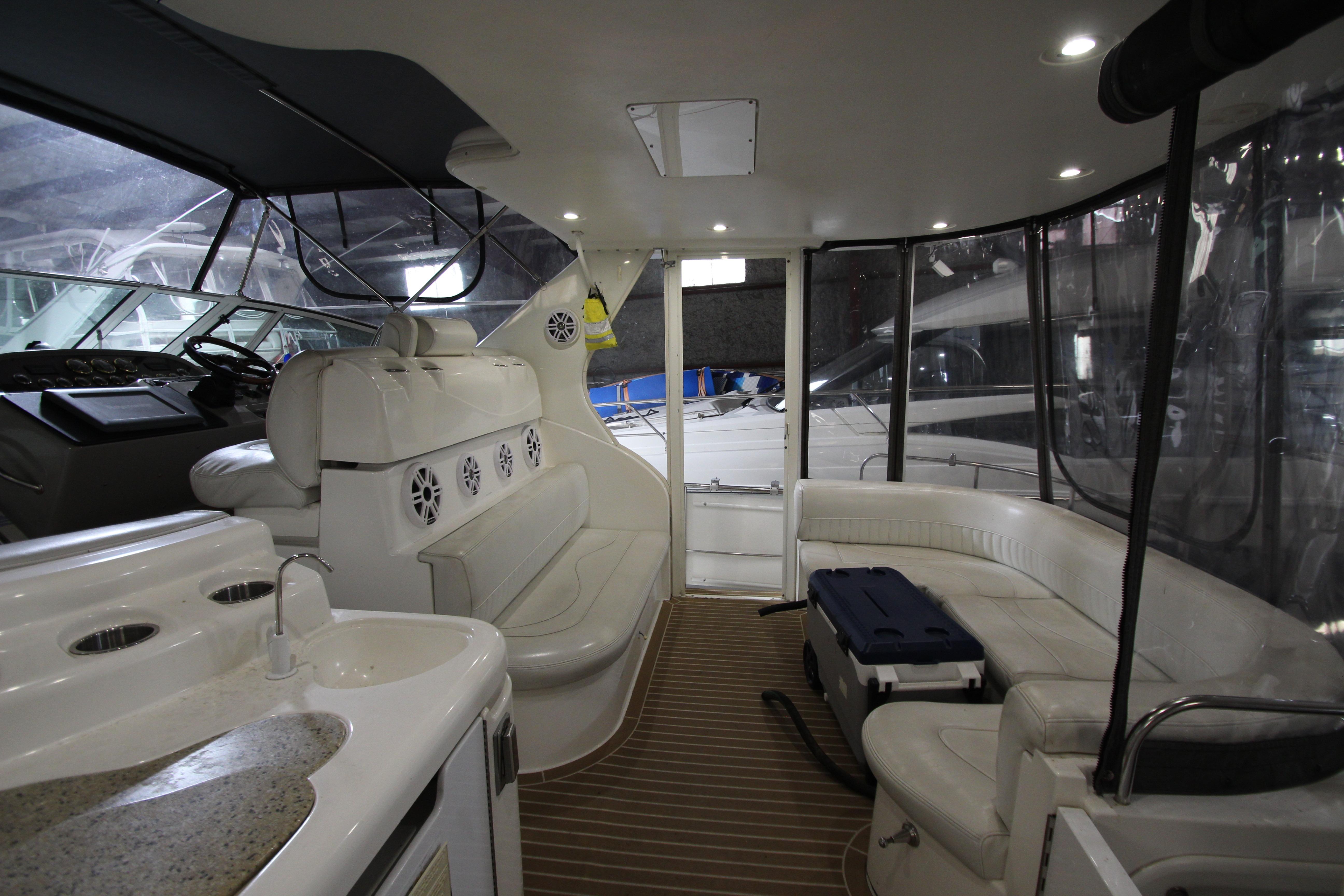 Luxurious interior of 2003 Cruisers Yachts 4450 Express Motoryacht with seating and helm.