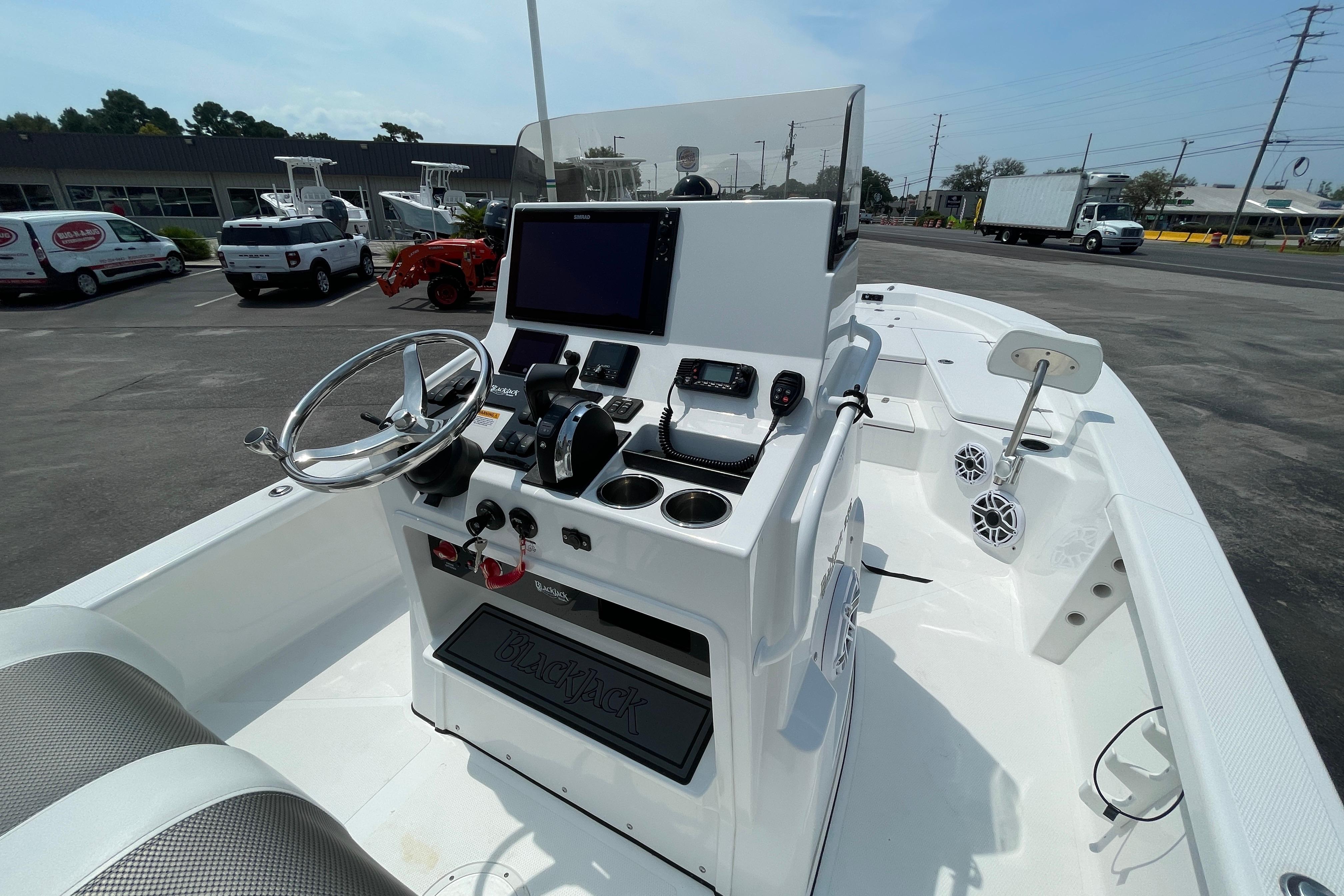 2023 BlackJack 256 Bay boat interior with steering console and navigation equipment.