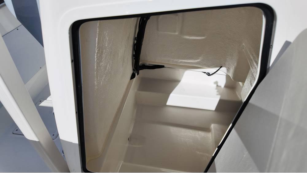 2025 Bayliner Trophy 20 boat storage compartment, open and empty, with white interior.
