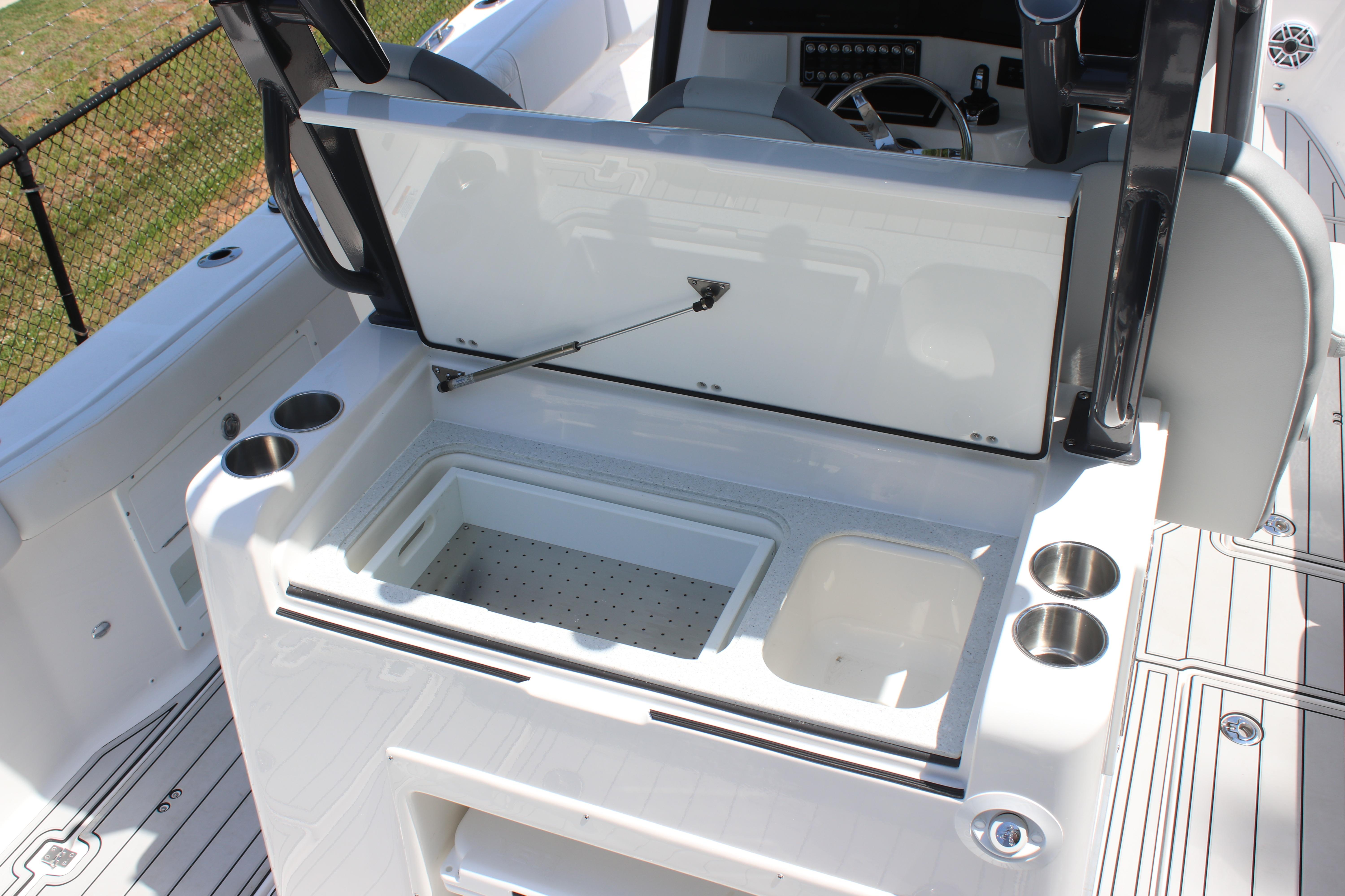 2025 Sea Fox 328 Commander boat interior with open storage compartment and cup holders.