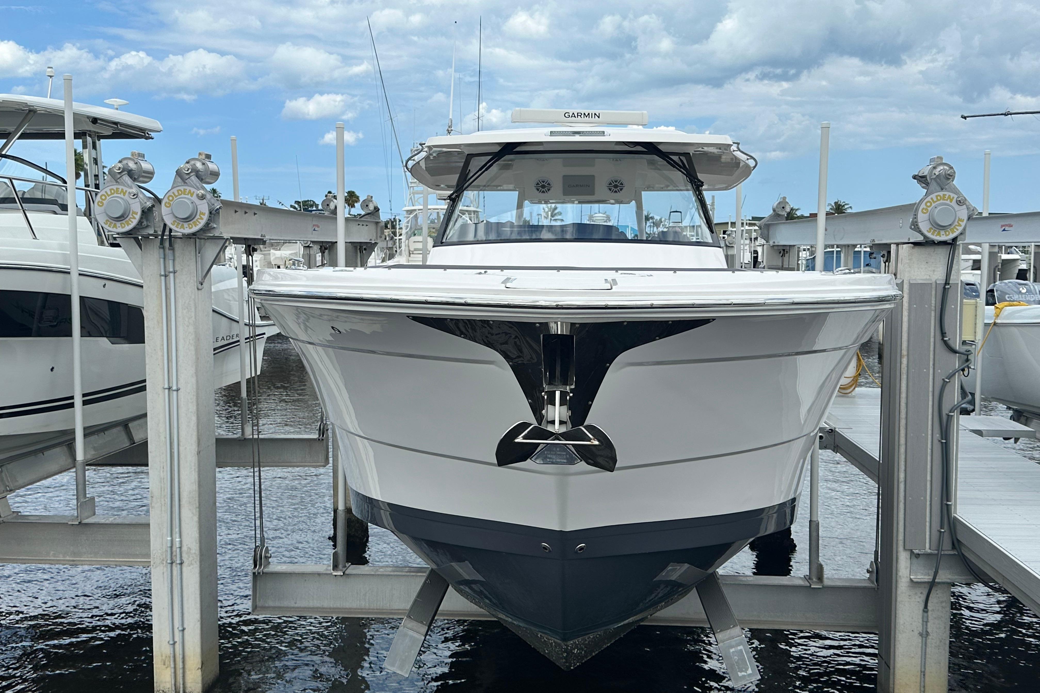 2025 Regal 38 SAV boat docked at marina under cloudy sky.