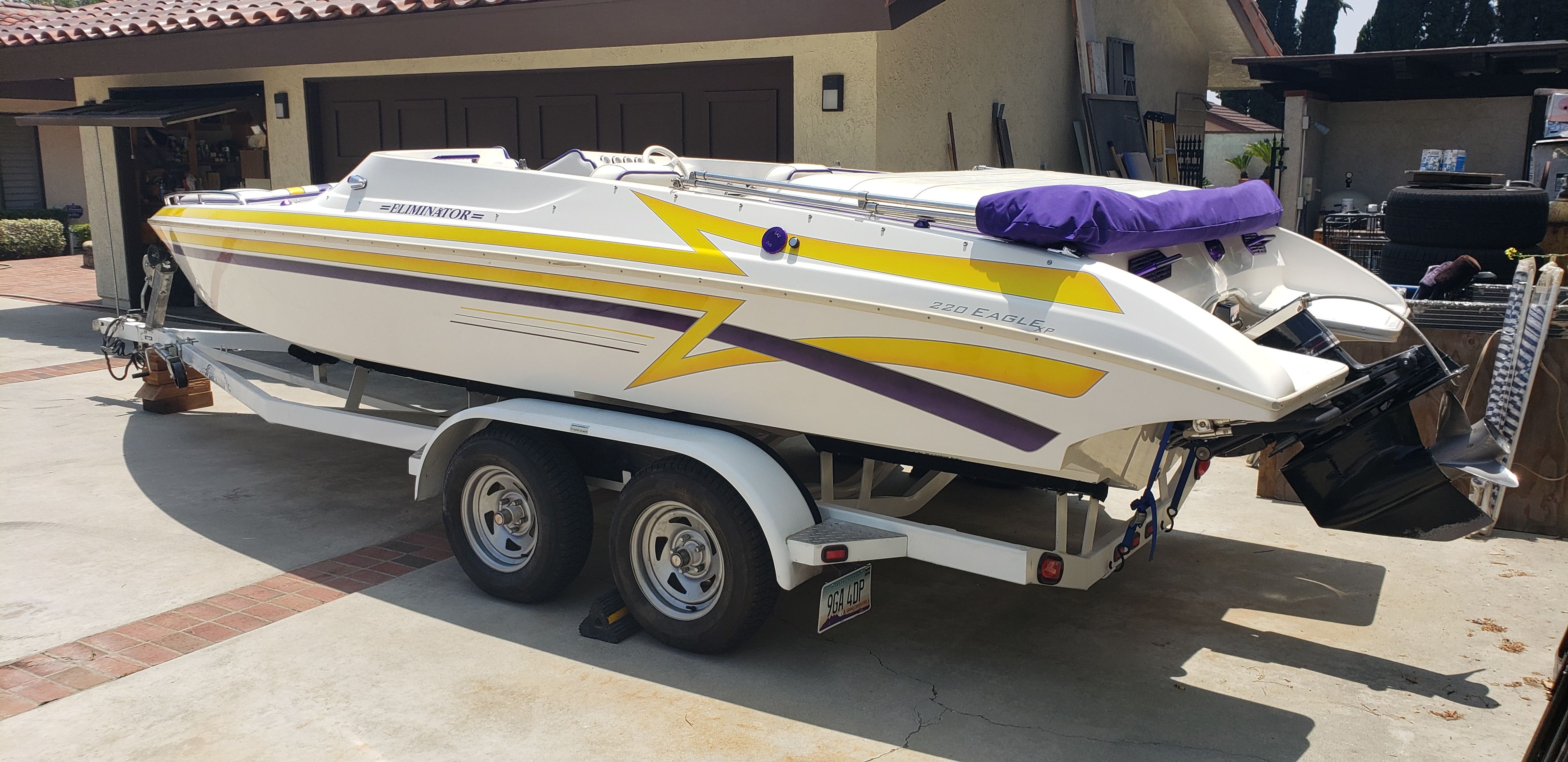 1999 Eliminator 220 Eagle XP boat on trailer in driveway.