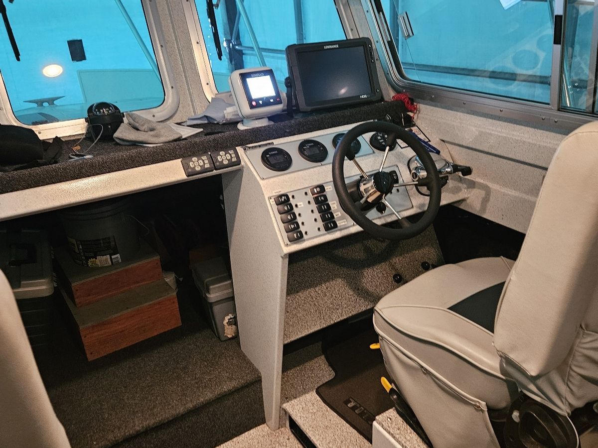 Interior of a 2015 Kingfisher Cruisers 2525 Offshore with helm and navigation equipment.