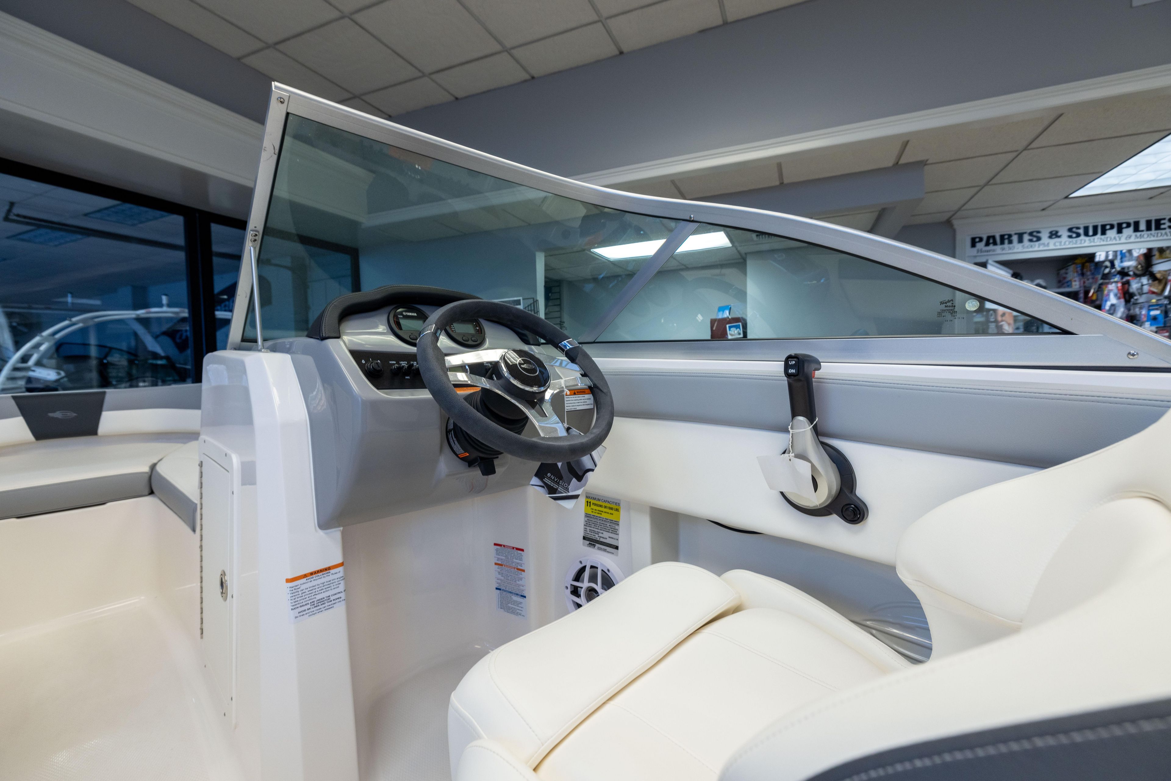 2024 Chaparral 19 SSi OB boat interior with steering wheel and controls.
