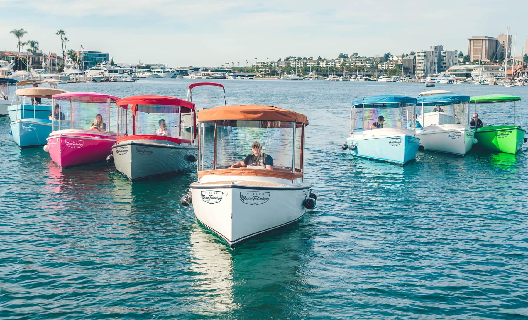 Colorful 2023 Vision Marine Technologies Fantail 217 boats on water, showcasing modern design.