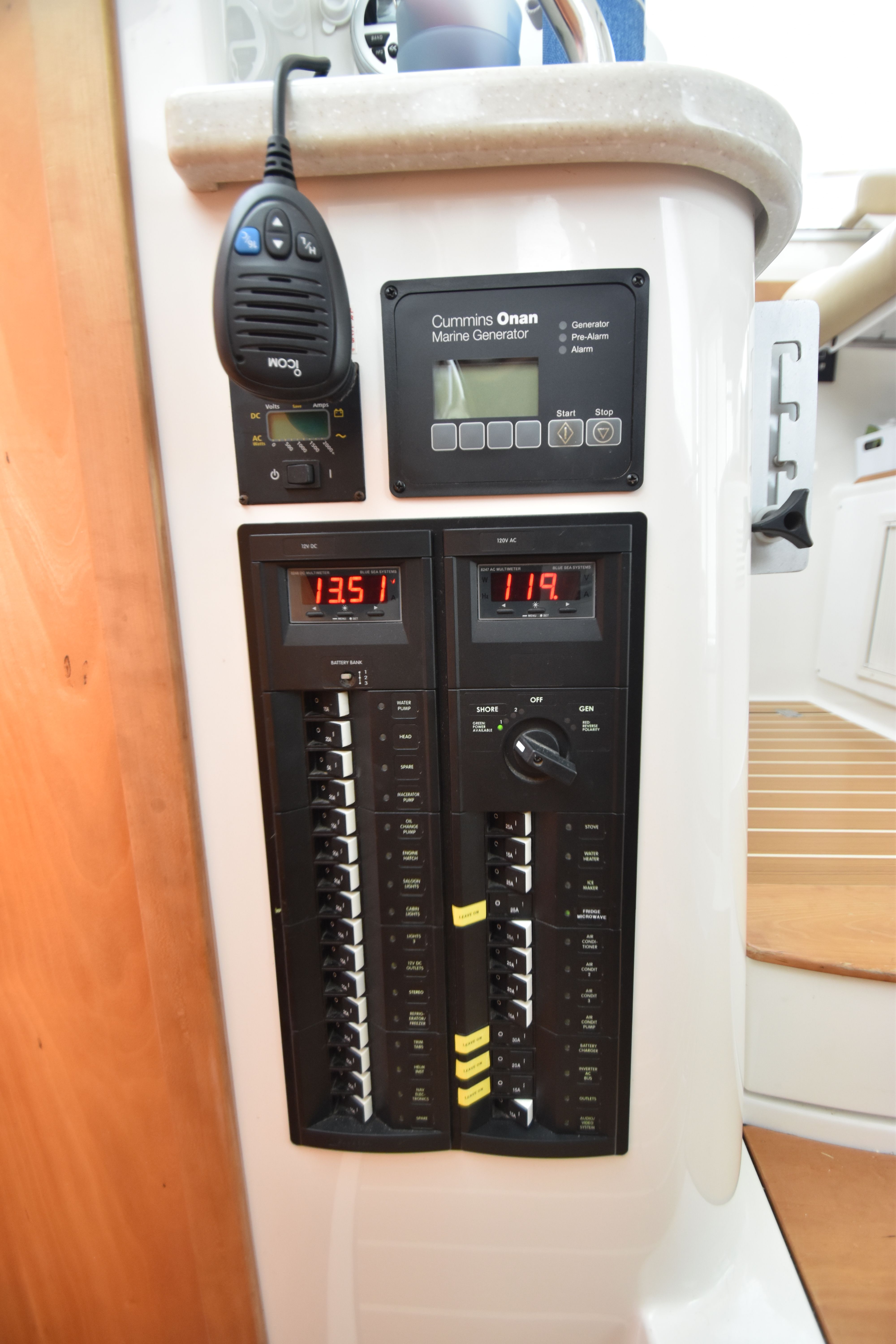 Electrical panel with Cummins Onan marine generator display and radio.